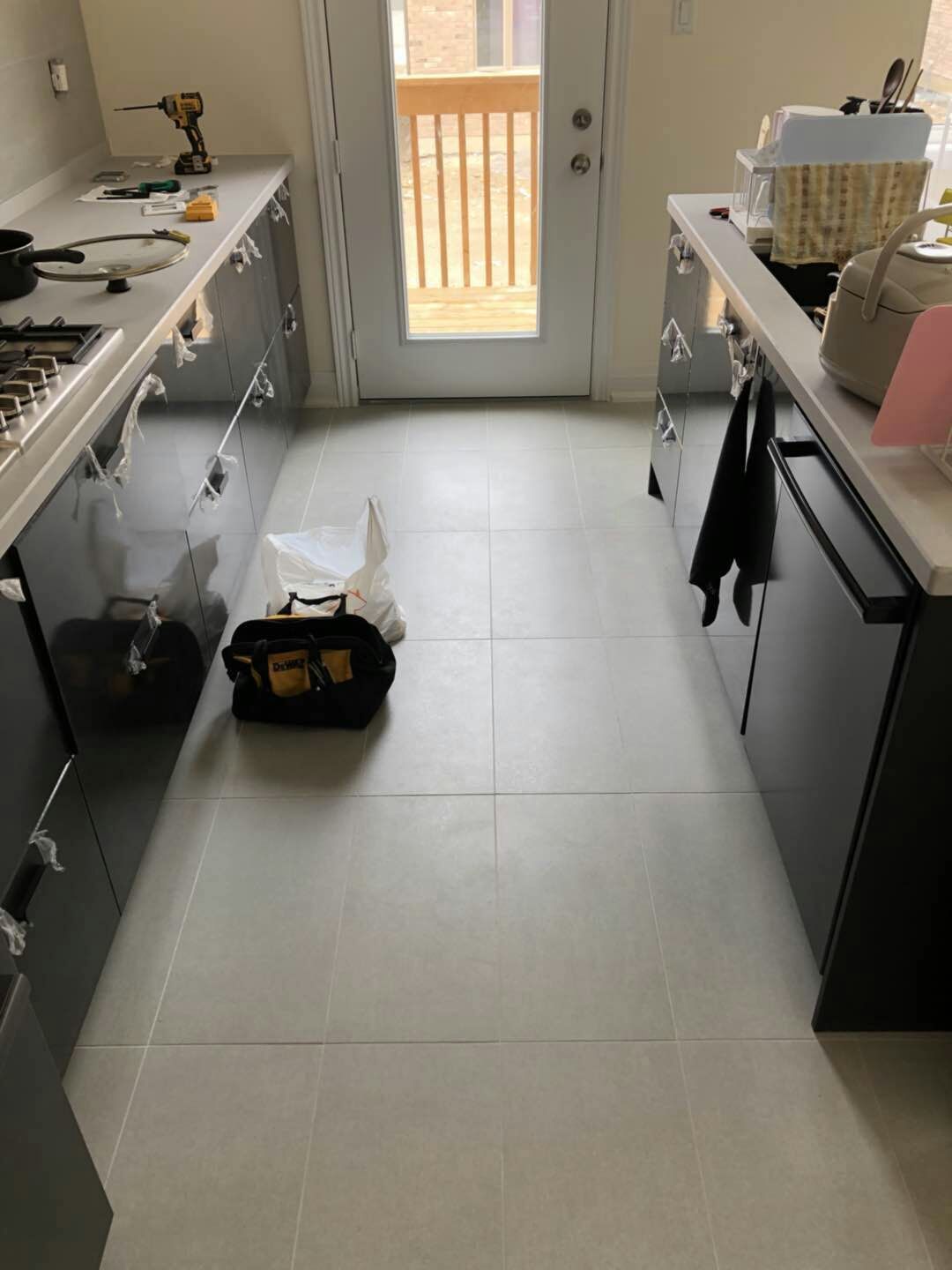Large-format tile flooring installation in a Toronto interior renovation project. Clean tile alignment, consistent grout lines, and precise layout preparation help create a modern, durable, and easy-maintenance living space for everyday use.