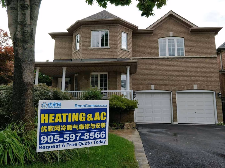 Professional outdoor air conditioner condenser installation by Reno Compass in Toronto. This energy-efficient HVAC unit is securely mounted on a raised stand with proper drainage and ventilation clearance, ensuring optimal cooling performance, durability, and safe operation for residential homes. Installed by licensed technicians for long-term reliability and comfort.