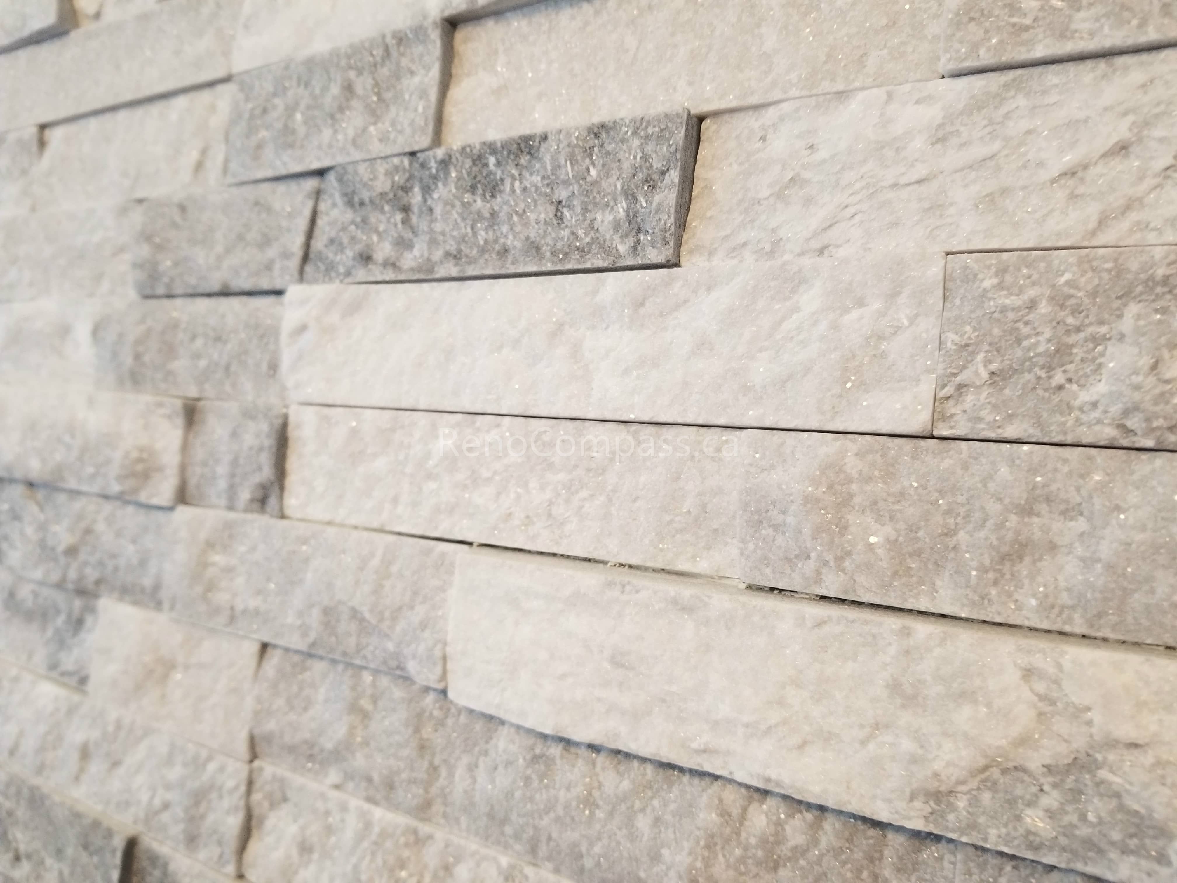 Close-up detail of a modern stacked stone feature wall from a Mississauga interior renovation project. The neutral-toned stone texture adds depth, elegance, and a contemporary luxury feel to the living space.

Installed by Reno Compass Inc., this custom interior wall finish enhances the home’s visual appeal while creating a sophisticated focal point that complements modern fireplace and living room designs.