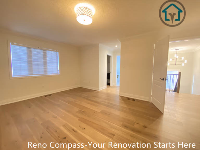 This image features a newly renovated bedroom as part of a flooring and interior renovation project in Richmond Hill. The space is finished with wide-plank hardwood flooring, soft neutral wall colors, and clean white trim, creating a bright and welcoming atmosphere. Updated lighting and smooth floor transitions enhance both comfort and functionality. Completed by a trusted Toronto renovation company, this renovation focuses on durability, clean craftsmanship, and a timeless design suitable for everyday residential use.