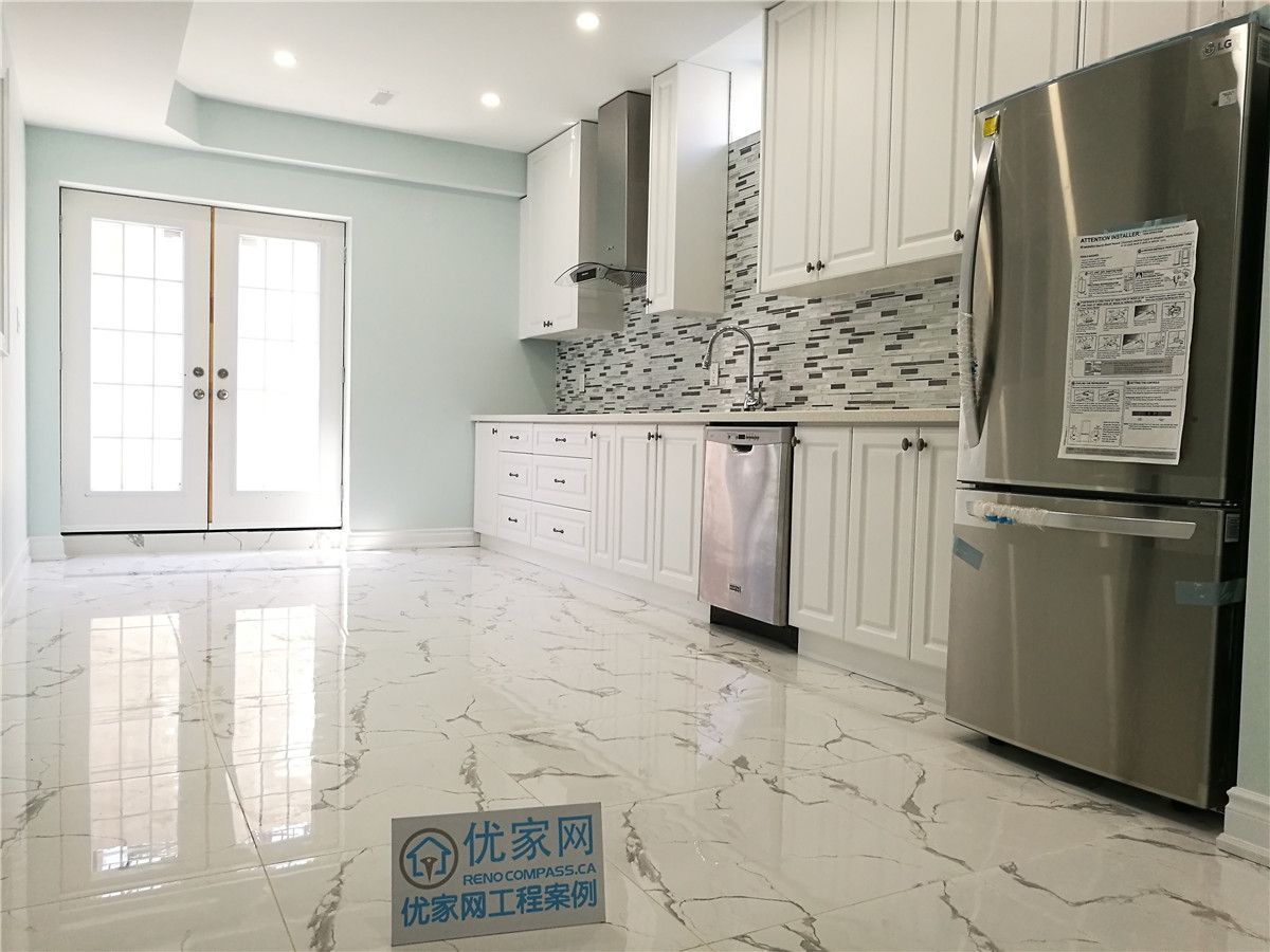 This Vaughan basement kitchen renovation features elegant white cabinetry, a contemporary mosaic backsplash, and glossy marble-look tile flooring for a bright and upscale finish. Stainless steel appliances and recessed lighting enhance functionality and style. Completed by a professional Toronto renovation company, this kitchen upgrade creates a modern, durable, and inviting space ideal for rental suites or family use.
