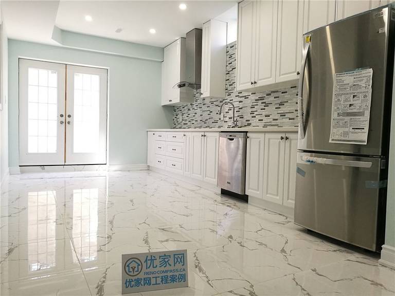 This Vaughan basement kitchen renovation features elegant white cabinetry, a contemporary mosaic backsplash, and glossy marble-look tile flooring for a bright and upscale finish. Stainless steel appliances and recessed lighting enhance functionality and style. Completed by a professional Toronto renovation company, this kitchen upgrade creates a modern, durable, and inviting space ideal for rental suites or family use.