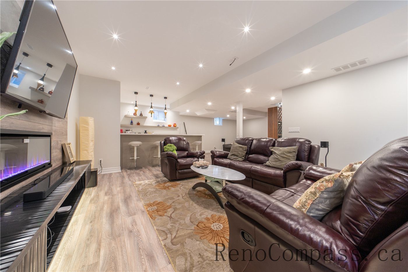 This Richmond Hill entire house interior renovation includes a fully finished basement featuring a modern entertainment and lounge area with a custom fireplace feature wall, recessed lighting, and durable flooring. The open layout provides a comfortable space for family gatherings, relaxation, and fitness activities. Professionally completed by a trusted Toronto renovation company, this basement renovation enhances usable living space while maintaining a stylish and functional design.