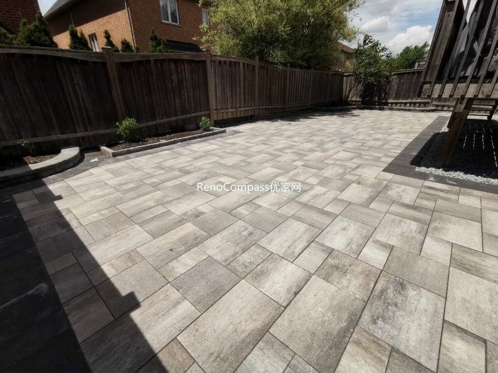 Beautifully designed interlocking driveway in Vaughan with a modern grey stone pattern. Expertly installed by Reno Compass, featuring durable pavers, clean lines, and low-maintenance landscaping to enhance curb appeal.