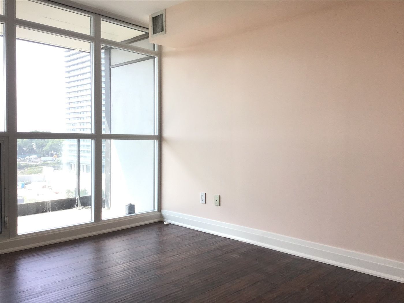 Bright and modern condo interior renovation in North York featuring upgraded flooring, fresh wall finishes, and large floor-to-ceiling windows that maximize natural light and city views. This clean and functional living space reflects contemporary condo design and quality workmanship. Completed by a professional Toronto renovation company, Reno Compass Inc., specializing in full condo and interior renovation projects.