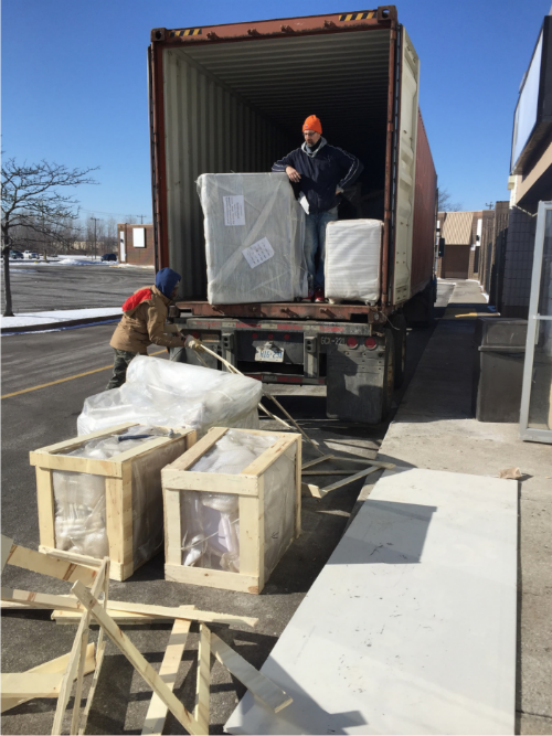 This image captures the equipment delivery phase of a 7000 sqft private club renovation project in Toronto. Large commercial fixtures and custom-built components are being unloaded from a shipping container, carefully prepared for interior installation.

The project involves coordinated logistics, material handling, and staged installation to ensure smooth construction progress. Deliveries like these typically include custom furniture, structural components, or entertainment-related equipment required for a high-end private club build-out.

Managed by an experienced Toronto renovation team, this large-scale commercial project demonstrates organized project planning, safe material handling, and professional construction workflow from delivery to final installation.

该图片展示多伦多7000尺私人俱乐部装修项目的设备到场阶段，大型商业设施与定制部件正在从集装箱中卸货，为后续室内安装做准备。

项目涉及物流协调、材料管理及分阶段安装安排，确保工程顺利推进。由专业多伦多装修团队统筹管理，体现大型商业装修项目从材料进场到施工安装的规范流程与专业度。