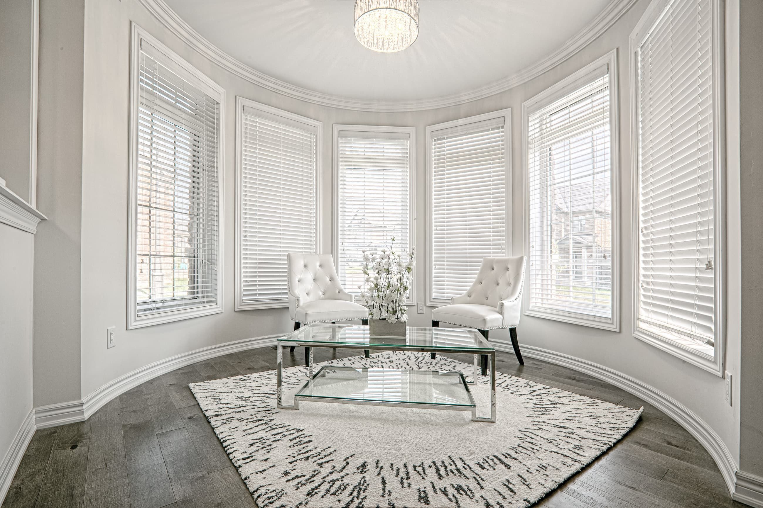 This Toronto luxury sitting area renovation features a bright curved bay window design that fills the space with natural light and enhances the open, elegant atmosphere. The interior showcases premium hardwood flooring, modern classic furnishings, and refined ceiling lighting that create a sophisticated lounge area for relaxation. Completed by a professional Toronto renovation company, this project highlights functional luxury, timeless design, and high-end residential interior craftsmanship tailored for contemporary living.