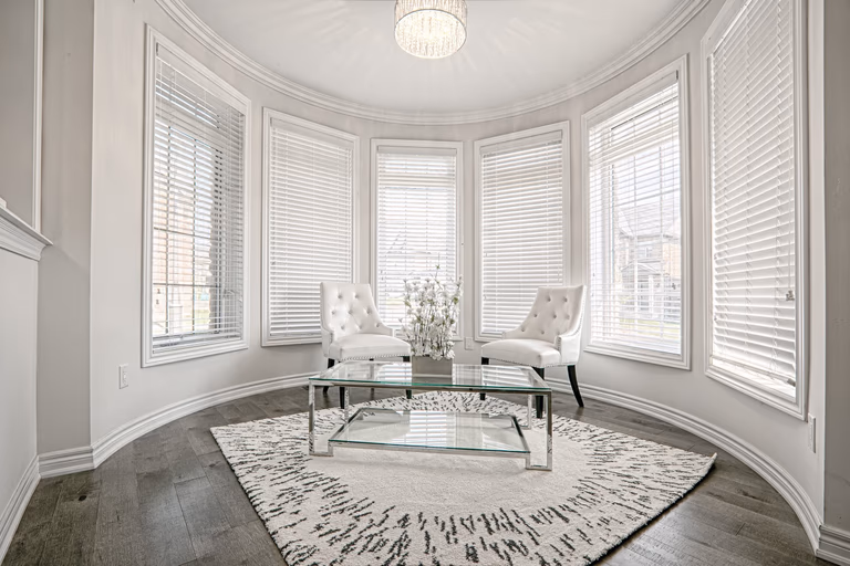 This Toronto luxury sitting area renovation features a bright curved bay window design that fills the space with natural light and enhances the open, elegant atmosphere. The interior showcases premium hardwood flooring, modern classic furnishings, and refined ceiling lighting that create a sophisticated lounge area for relaxation. Completed by a professional Toronto renovation company, this project highlights functional luxury, timeless design, and high-end residential interior craftsmanship tailored for contemporary living.
