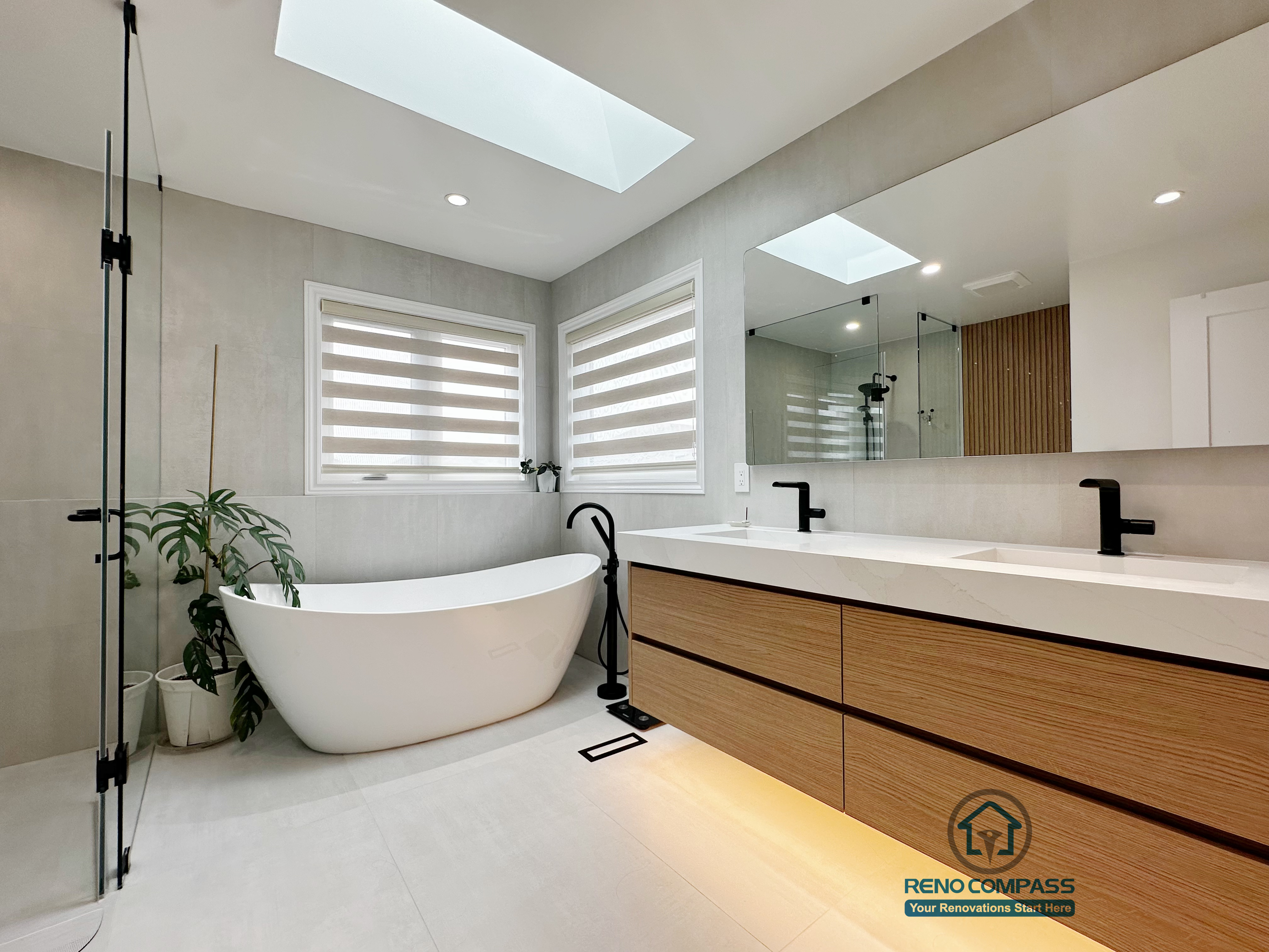 A floor-level view of a curbless bathroom renovation by Reno Compass in Markham, Toronto.
This image highlights the seamless tile flooring, integrated linear drainage, and warm under-vanity lighting that enhance accessibility, safety, and visual continuity.