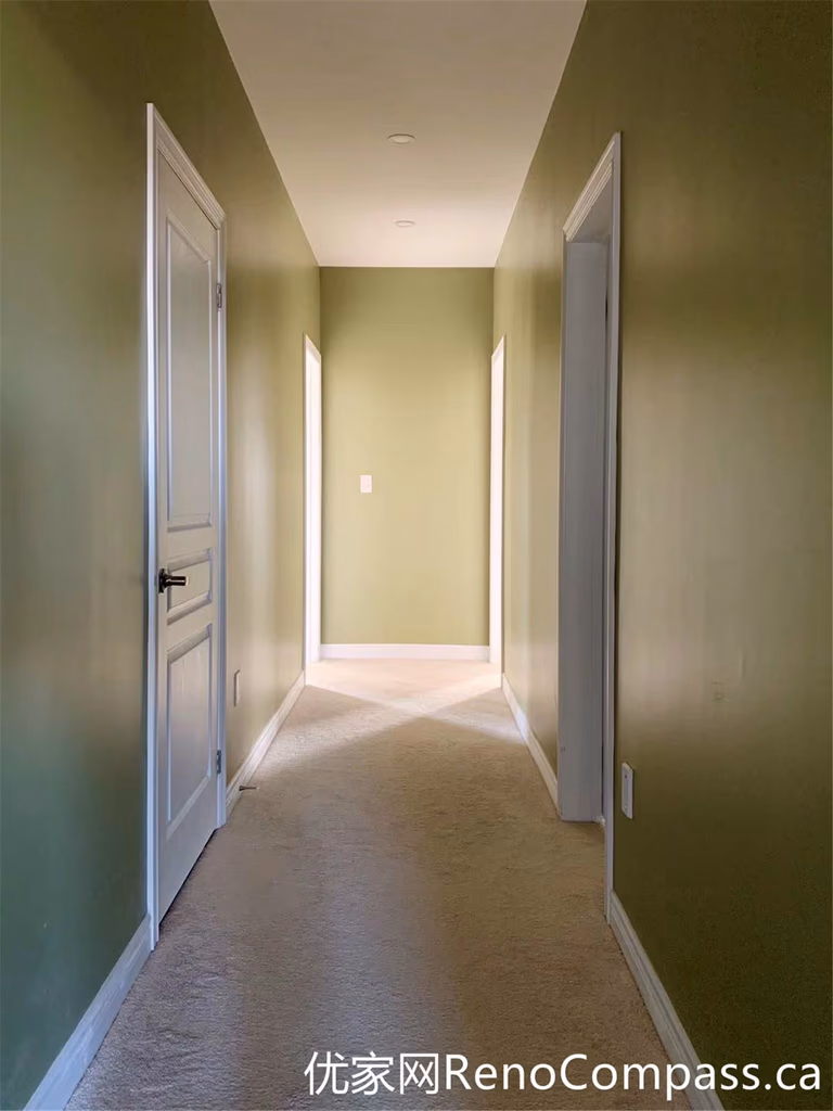 This hallway from a Markham full home renovation features soft green walls, clean white trim, and a simple, functional layout. Natural light enhances the depth of the space, while the updated finishes create a cohesive transition between rooms with a calm and modern feel.
