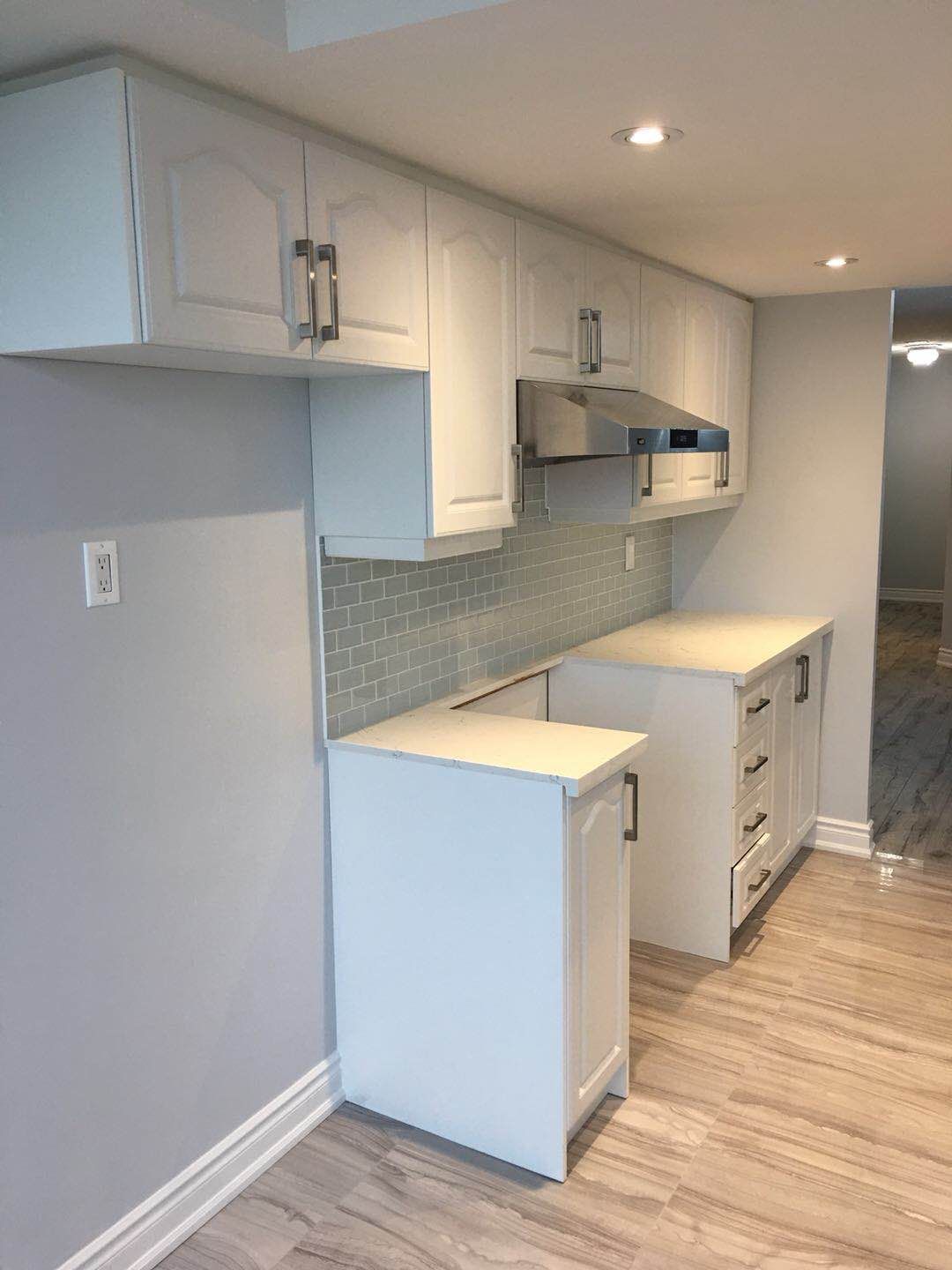 This Toronto interior renovation project features a bright and modern kitchen upgrade with custom white cabinetry, quartz countertops, and a stylish subway tile backsplash. The space was designed to maximize storage, improve lighting, and create a clean contemporary look suitable for everyday living in a Toronto condo.