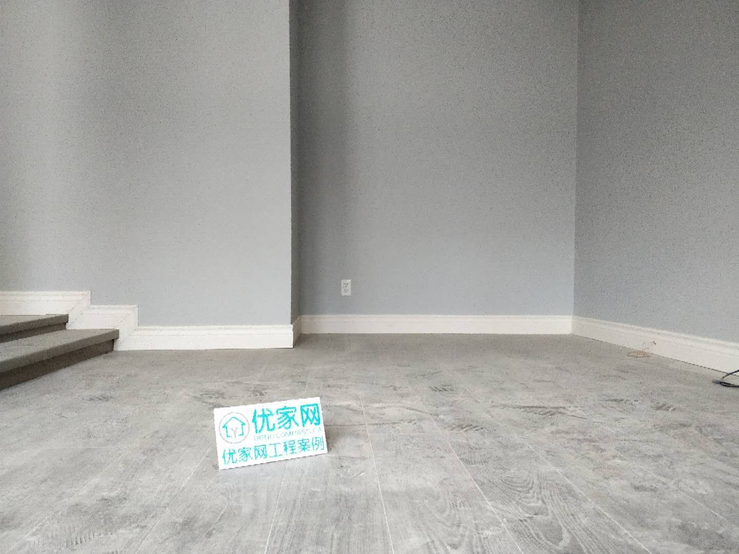 This living area renovation in Ajax features modern grey-tone flooring, clean wall finishes, and a minimalist interior layout. The updated space highlights improved durability and a contemporary aesthetic, creating a bright and open environment. As part of a full house renovation project, the flooring and wall upgrades enhance both comfort and long-term value for the homeowner.