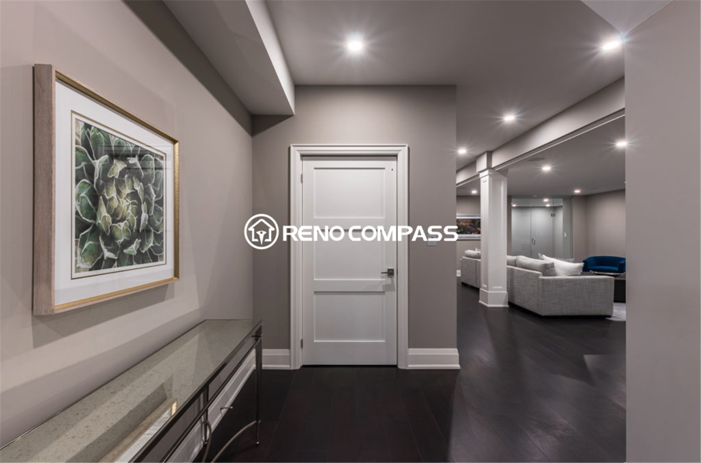 Modern luxury basement renovation in Toronto featuring elegant hallway design, recessed ceiling lighting, dark hardwood flooring, and an open-concept entertainment area. This professionally finished basement space was completed by a trusted Toronto renovation company, Reno Compass Inc., creating a stylish and functional living environment.
