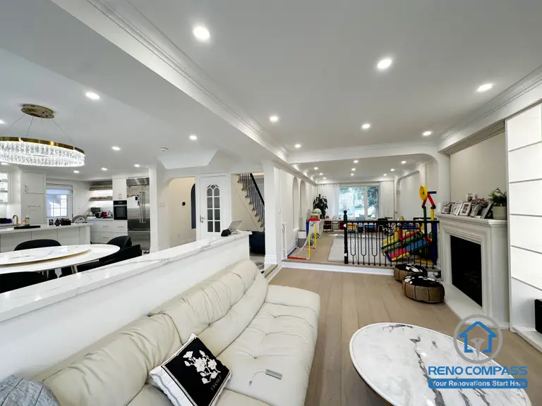 This Markham interior renovation reimagines the main living area as a bright, open-concept space that seamlessly connects lounging, dining, and family activity zones. The layout is designed to enhance visual continuity while maintaining comfortable separation between different functions of the home.

A half-height partition helps define the living room without blocking sightlines, allowing natural light to flow through the space. Recessed ceiling lighting and consistent architectural details create a clean, cohesive look throughout the interior. The open connection to the kitchen and family areas supports everyday interaction and makes the space ideal for both relaxation and entertaining.

By focusing on layout balance, lighting design, and long-term usability, this renovation delivers a refined yet practical interior environment suited for modern family living in Markham.