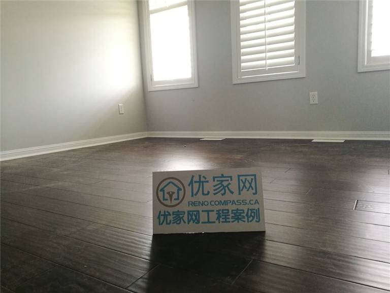 This Scarborough flooring replacement project features newly installed dark hardwood flooring that enhances the room’s depth and modern appeal. The rich wood tone contrasts beautifully with the light grey walls and white baseboards, creating a clean and contemporary atmosphere. Installed by a professional Toronto Renovation Company, the flooring was precisely aligned for a seamless finish and long-term durability.