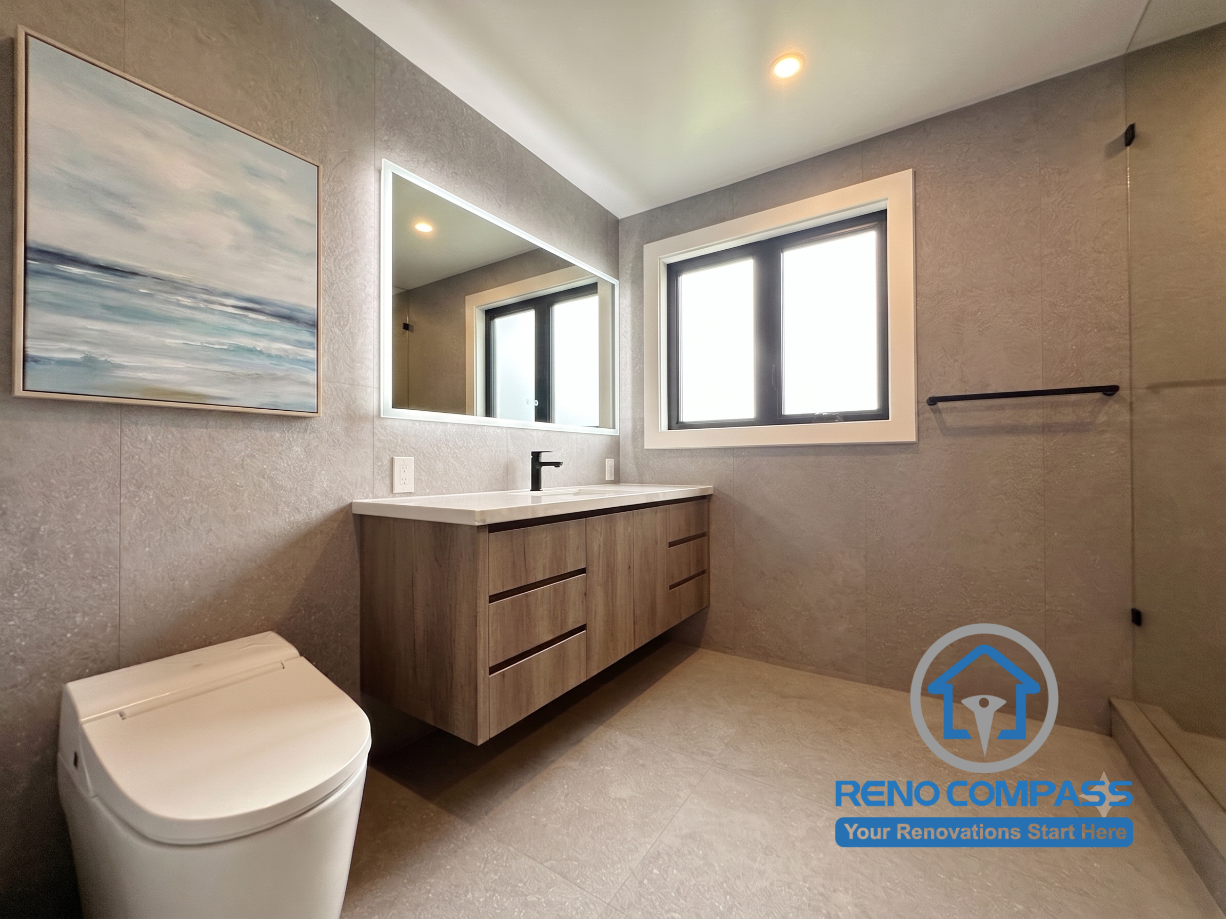 This luxury bathroom renovation features a spacious walk-in shower, floating vanity, integrated LED mirror, and large-format porcelain tiles. Designed with clean lines and contemporary finishes, the space offers a spa-like atmosphere while maximizing comfort, functionality, and ease of maintenance. Project completed by Reno Compass, serving Markham, Toronto, Richmond Hill, Vaughan, and the Greater Toronto Area.