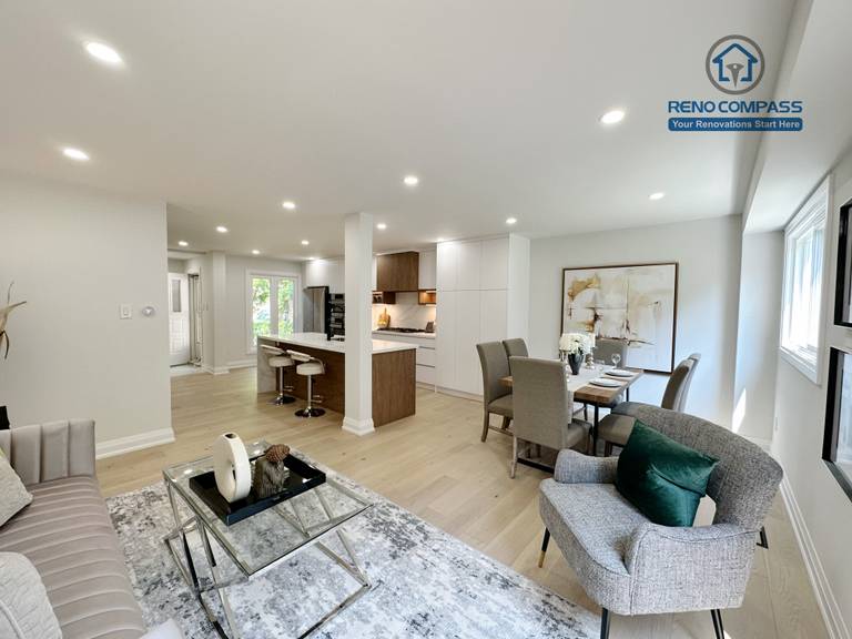 This Richmond Hill interior renovation showcases a spacious open-concept layout combining the living room, dining area, and modern kitchen. Light hardwood flooring, recessed ceiling lighting, and a cohesive neutral palette create a bright and seamless interior flow. Completed by a Toronto renovation company, the design enhances functionality, comfort, and modern family living.