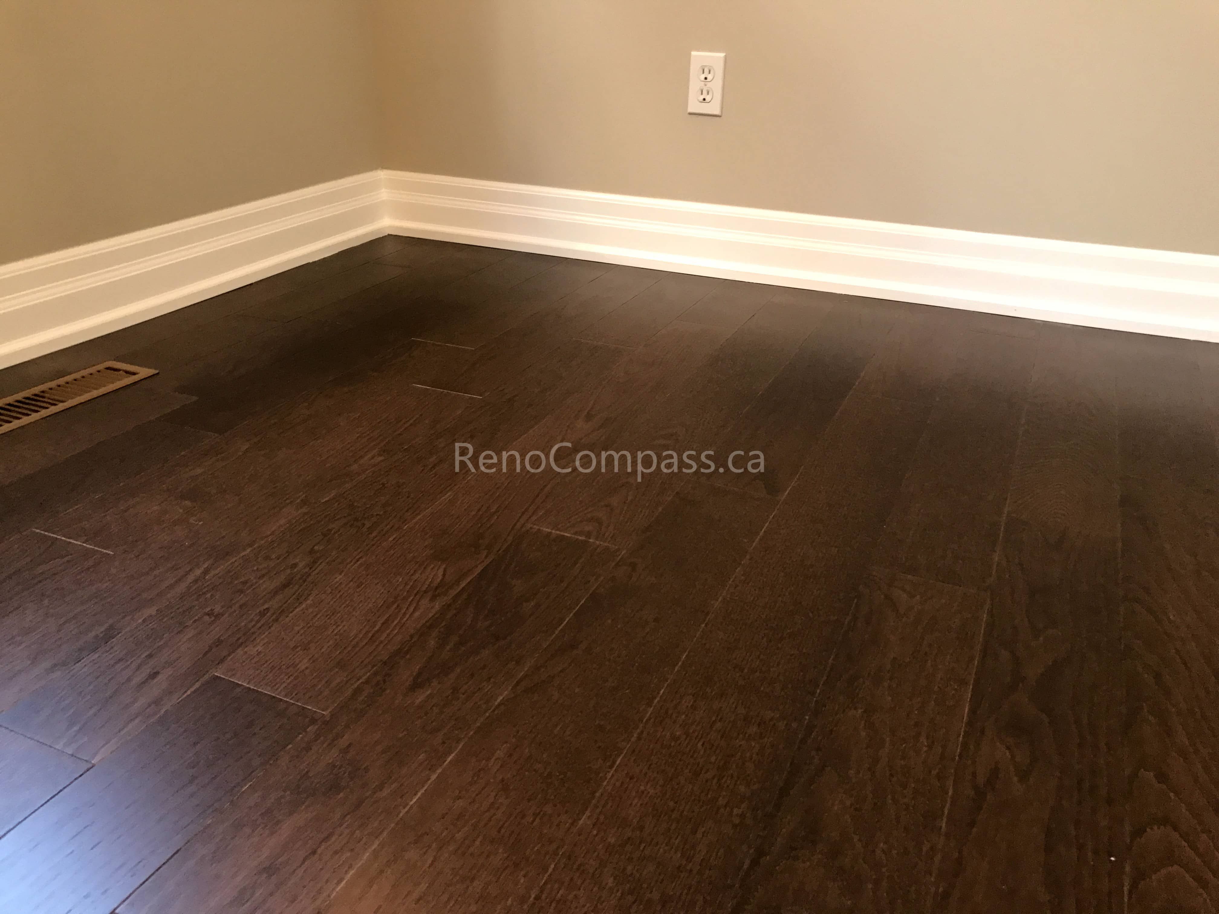 This Markham flooring renovation showcases newly installed dark hardwood flooring with a smooth, polished finish that enhances the warmth and elegance of the living space. The rich wood tones create depth and contrast while maintaining a modern and timeless interior style. Completed by a professional Toronto renovation company, the installation ensures precise plank alignment, durable materials, and a seamless flooring upgrade designed for long-term residential use.