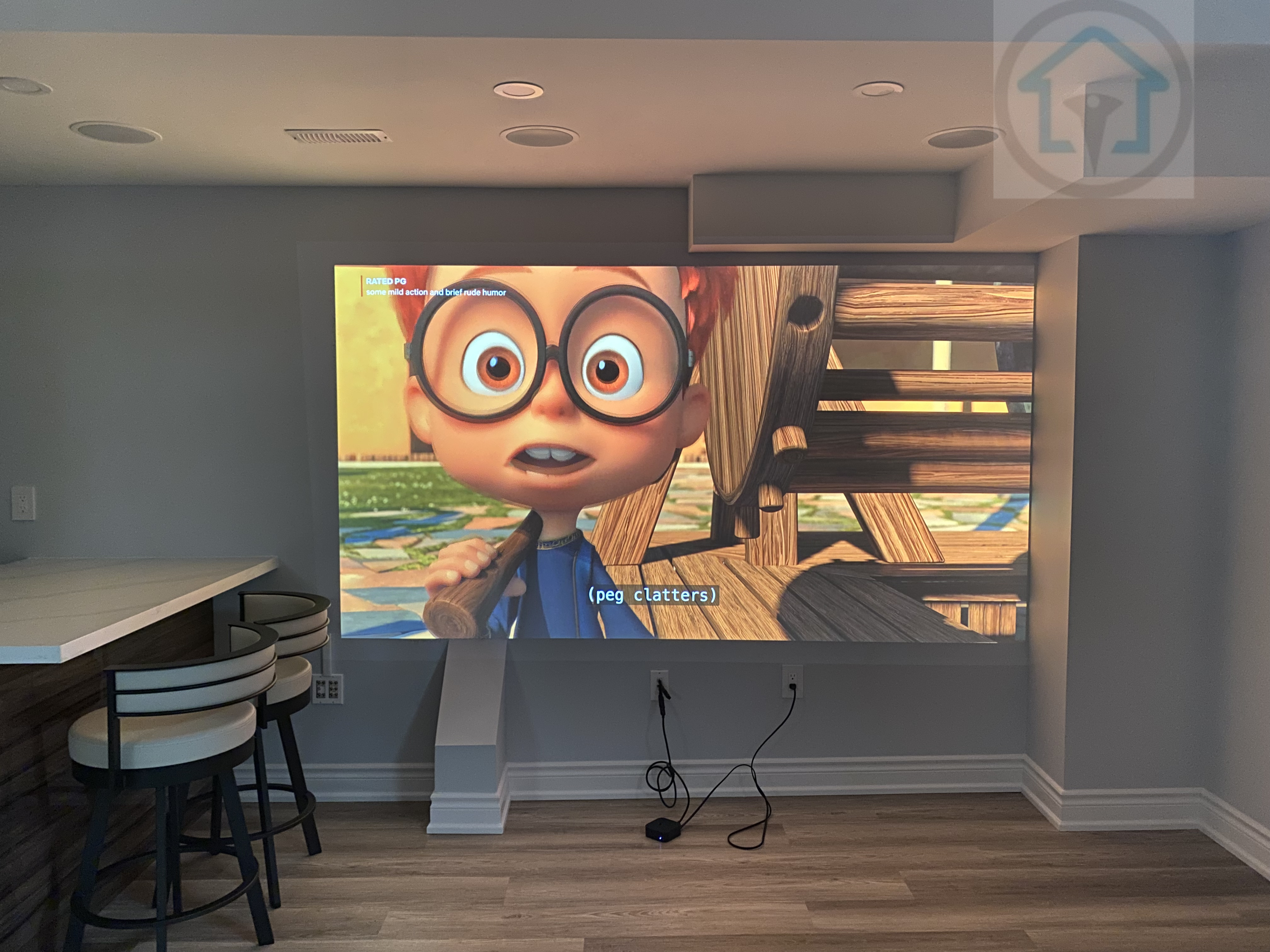 This Vaughan basement renovation includes a dedicated home theater and entertainment area with a projection wall, recessed ceiling speakers, and integrated lighting. The clean wall layout and open connection to the kitchen seating area create a versatile basement space suitable for movie nights, family entertainment, and everyday relaxation.