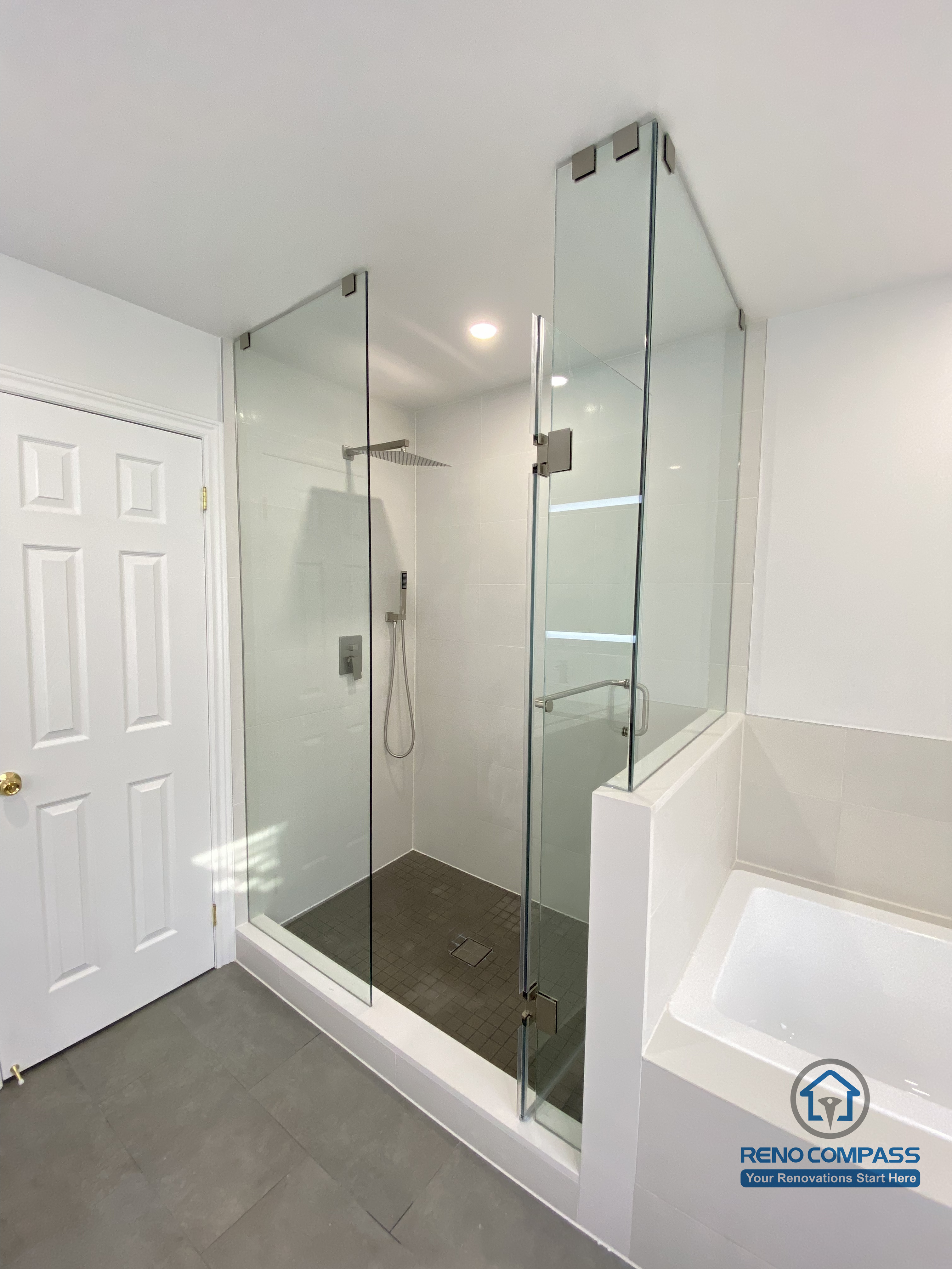 This Markham bathroom renovation showcases a modern glass-enclosed shower paired with an integrated bathtub layout. The frameless glass panels, rainfall shower system, and large-format floor tiles create a clean, functional, and space-efficient design. Completed by a professional Toronto renovation company, this bathroom balances comfort, durability, and contemporary aesthetics.