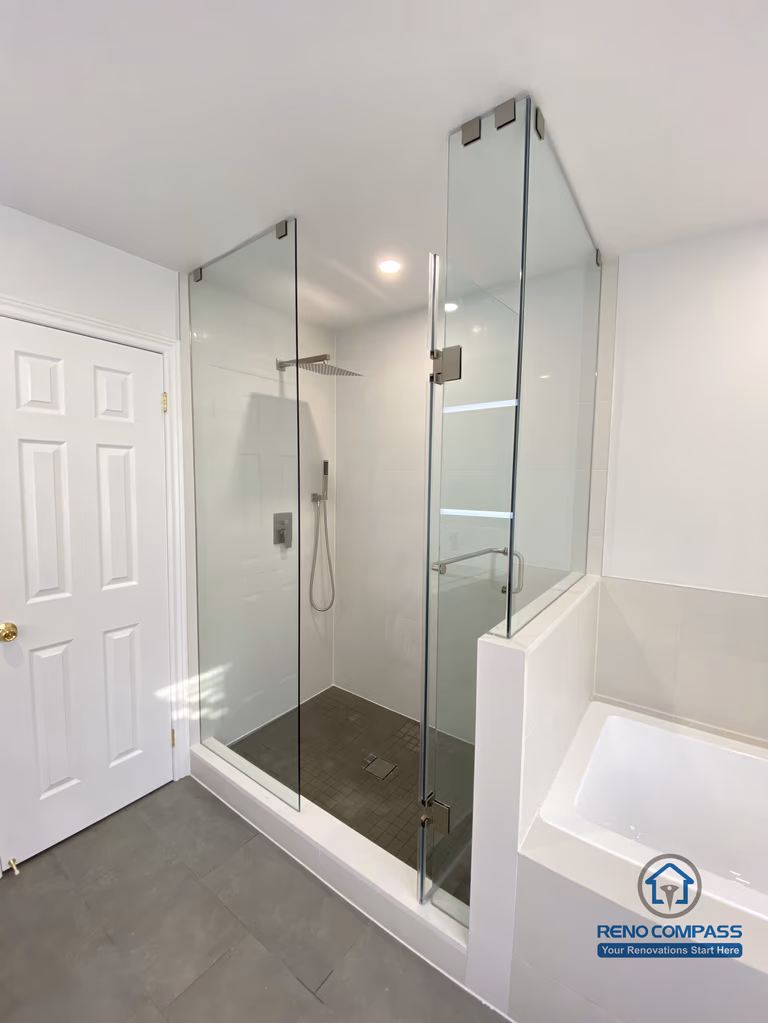 This Markham bathroom renovation showcases a modern glass-enclosed shower paired with an integrated bathtub layout. The frameless glass panels, rainfall shower system, and large-format floor tiles create a clean, functional, and space-efficient design. Completed by a professional Toronto renovation company, this bathroom balances comfort, durability, and contemporary aesthetics.