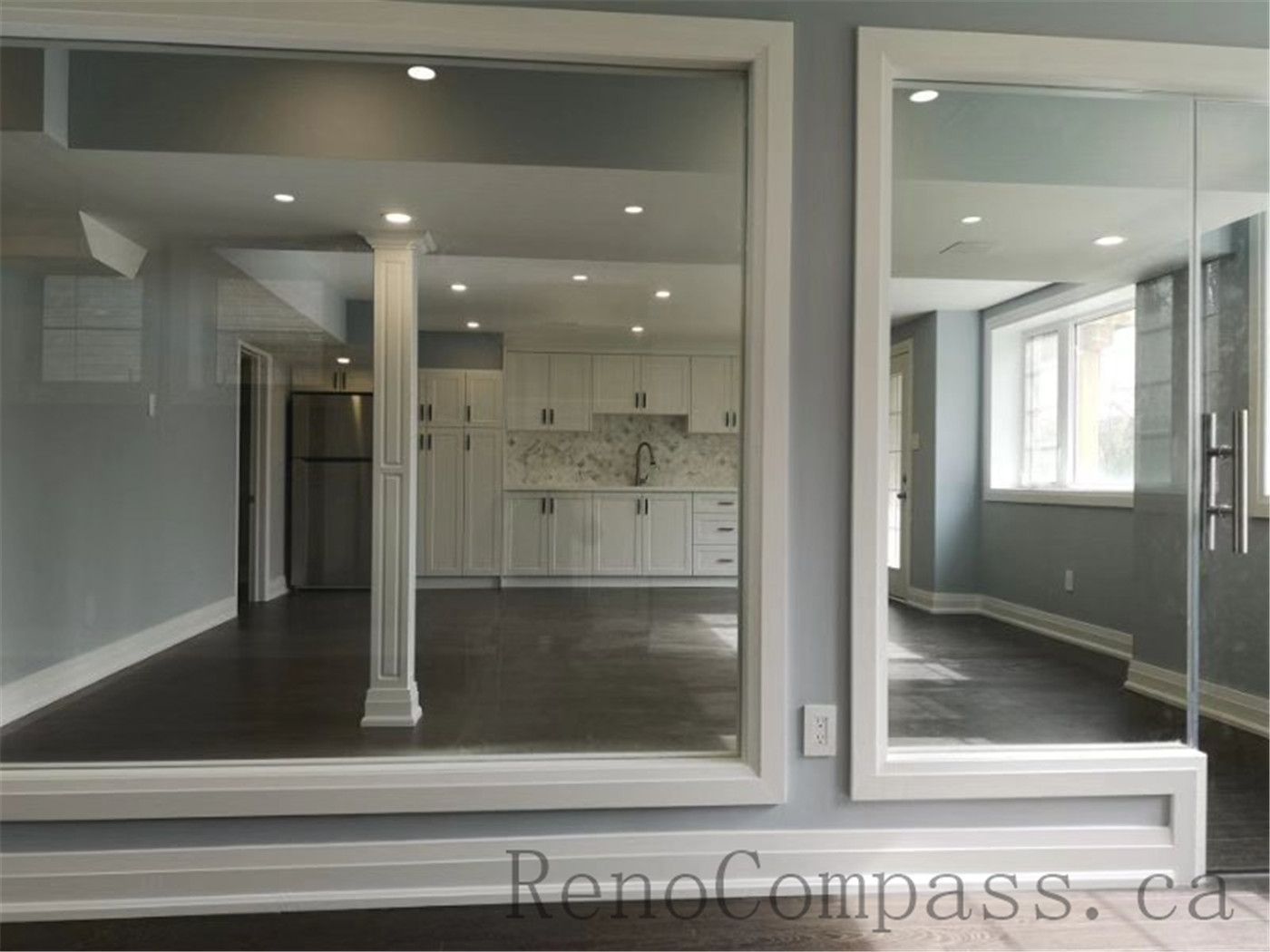 Contemporary basement renovation with a glass partition wall, maximizing natural light and creating an open, seamless flow between spaces. A refined Aurora project designed and built by Reno Compass.