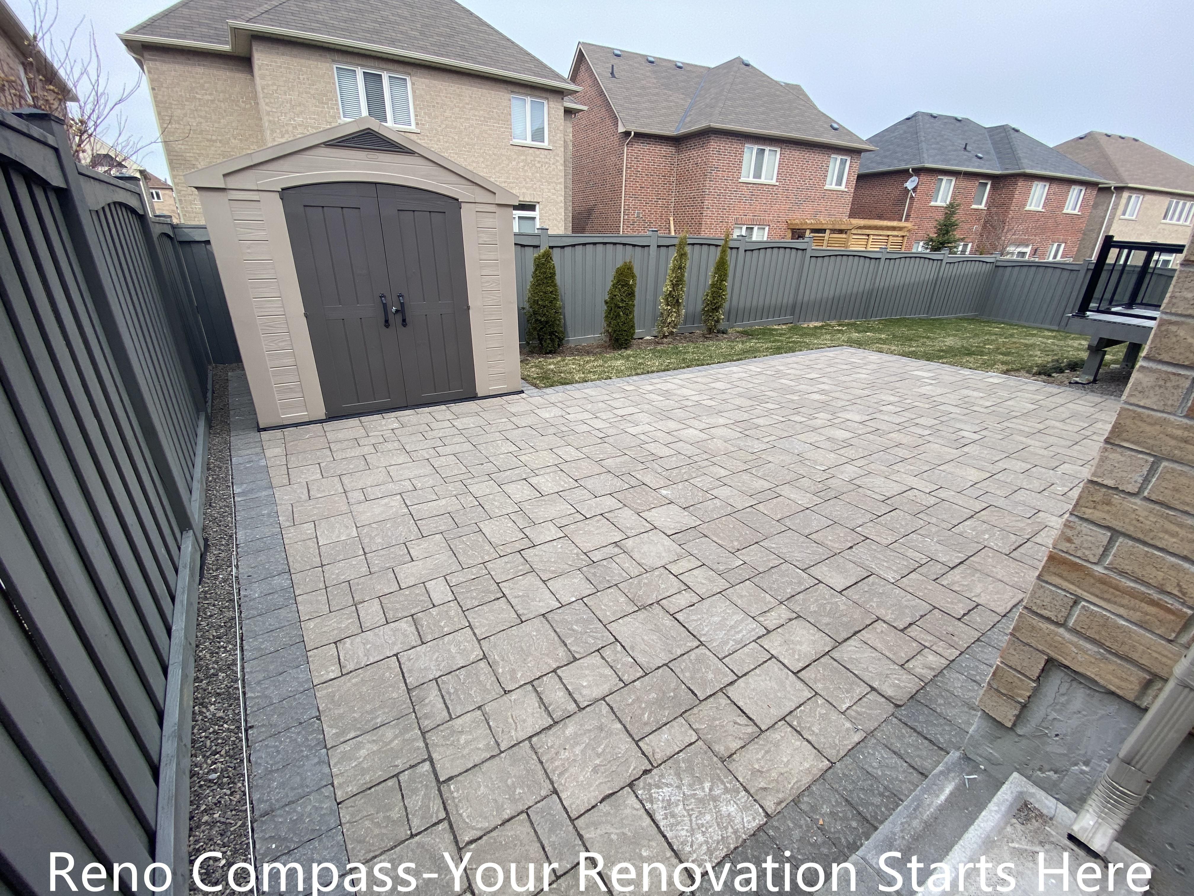 Backyard interlocking patio renovation in Newmarket featuring a spacious paved surface with integrated storage shed access and clean edge detailing. The layout improves outdoor functionality, provides a stable foundation for storage use, and maintains a tidy, low-maintenance backyard environment. Completed by a professional Toronto renovation company specializing in durable residential exterior renovations.
