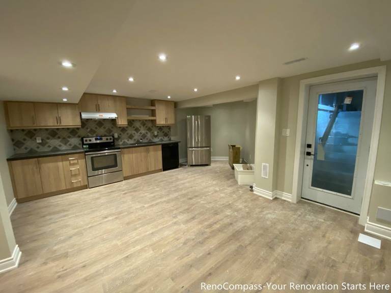 This Aurora basement renovation features a fully upgraded open-concept kitchen and living space designed for everyday use and long-term durability. The project includes custom wood-tone cabinetry, stainless steel appliances, patterned tile backsplash, and recessed ceiling lighting that brightens the entire basement. Durable flooring and a clean, neutral color palette create a cohesive and inviting environment, making the basement suitable for family use, entertaining, or rental potential. The layout was carefully planned to maximize space efficiency while maintaining a modern, functional aesthetic.
City: Aurora
Toronto Contractor: Reno Compass