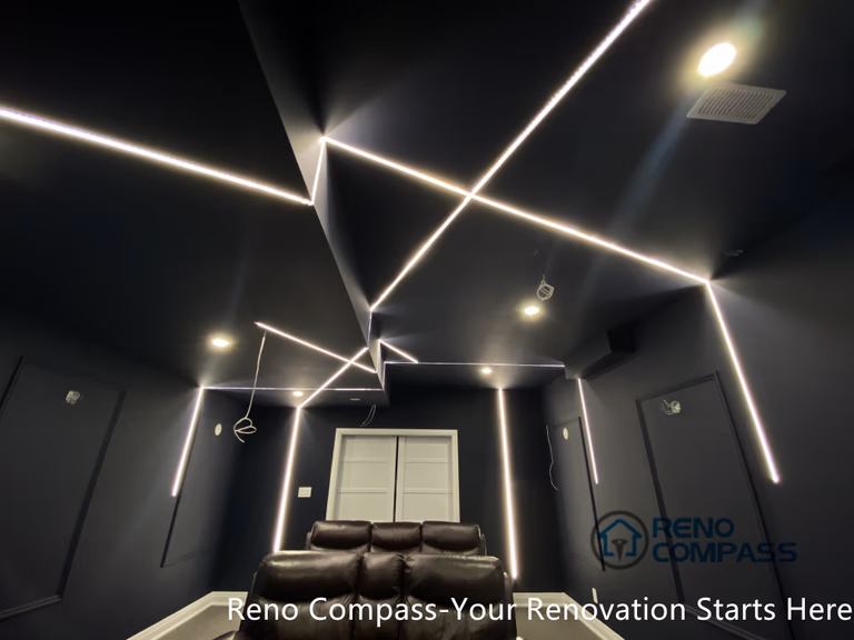 This Newmarket basement home theater renovation features a modern dark-tone design with custom recessed LED ceiling lighting, acoustic wall panels, and a dedicated media seating layout. Designed and built by an experienced Toronto renovation company, this basement transformation delivers a cinematic atmosphere while maintaining comfort, clean lines, and functional lighting control—ideal for family entertainment and private movie nights.