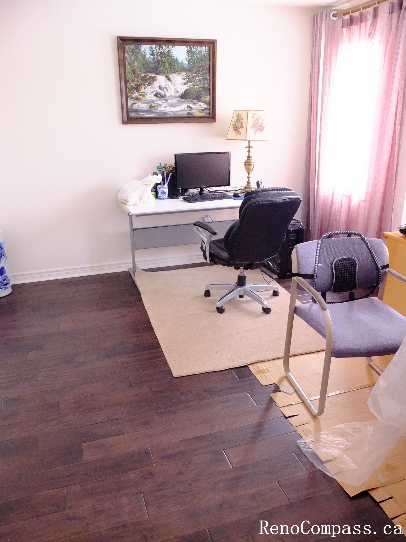 Toronto home hardwood flooring installation featuring deep-toned wood floors throughout the hallway and upper level. This professional flooring renovation enhances brightness, durability, and visual continuity, completed by Reno Compass for a clean and modern interior upgrade.