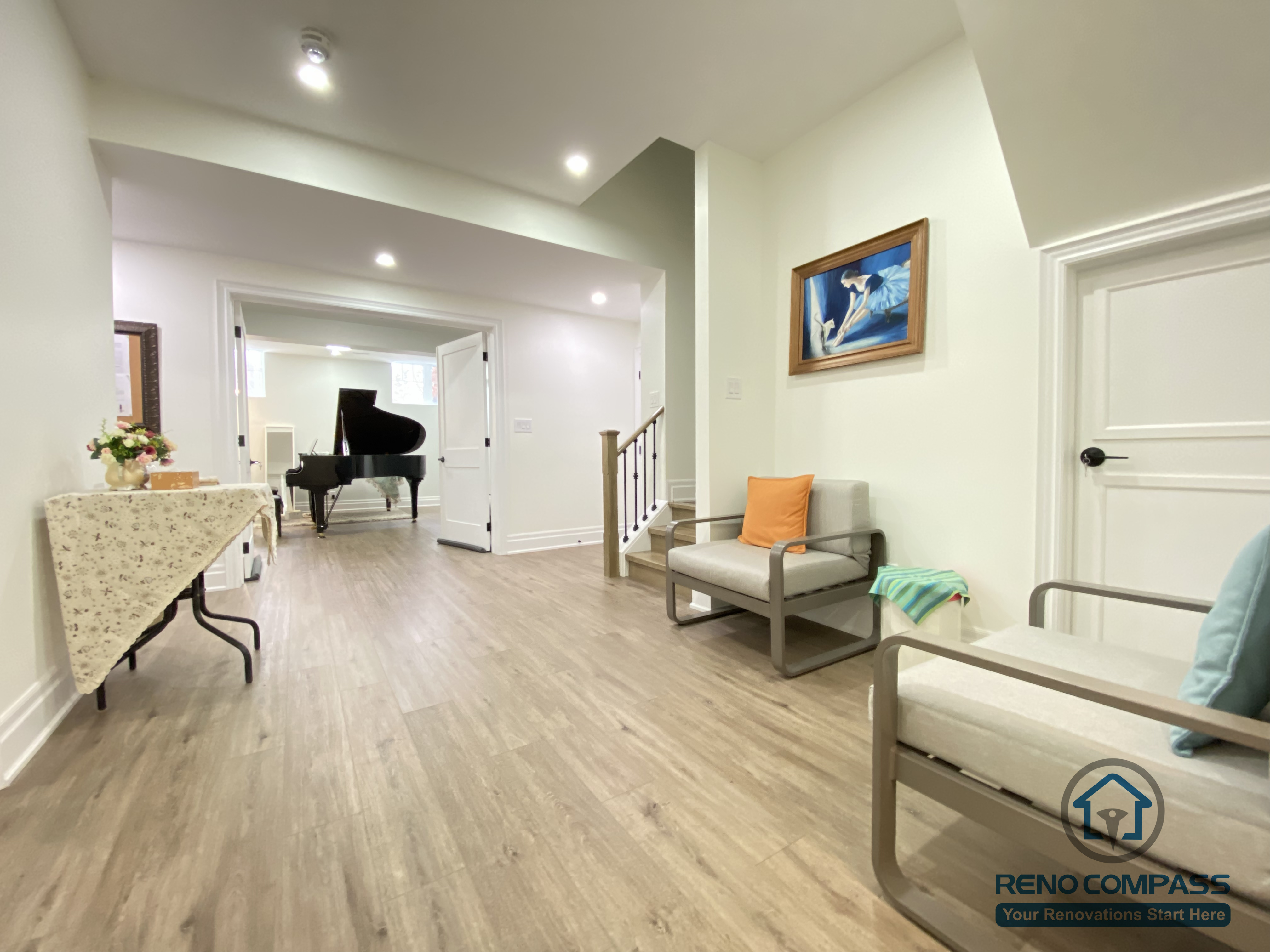 This Oakville basement renovation features an open-concept living area designed for relaxation, gatherings, and everyday use. The space includes continuous wood flooring, recessed ceiling lighting, and a comfortable seating arrangement that connects seamlessly to adjacent functional rooms. Clean architectural lines and neutral finishes create a calm, balanced atmosphere, while wide circulation paths improve usability. As a professional Toronto renovation company, Reno Compass transforms basements into versatile living spaces that support entertainment, comfort, and long-term flexibility.