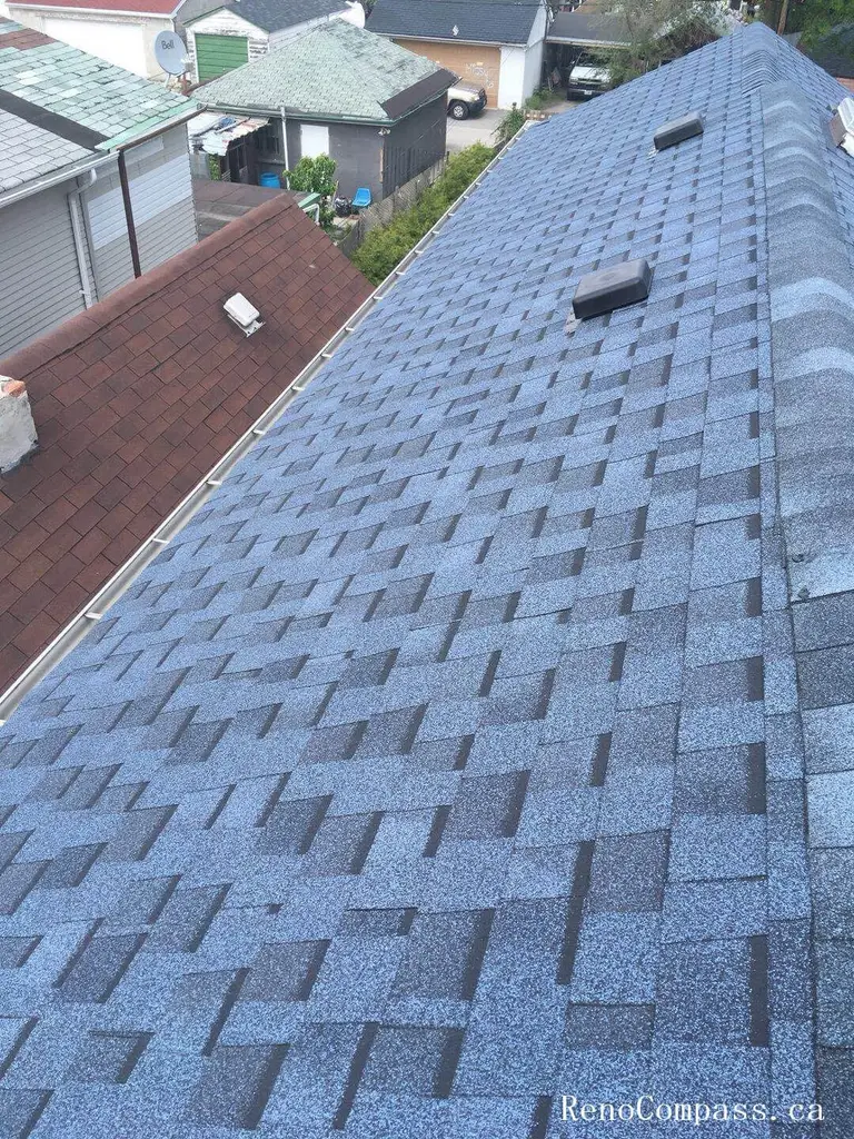 This image features the completed result of a residential roof replacement project in Toronto, showcasing newly installed asphalt shingles with a clean and uniform finish. The upgraded roofing system includes proper ventilation components and carefully aligned shingle placement to ensure long-term durability and protection against Toronto’s changing weather conditions. The project focuses on improving structural reliability, waterproof performance, and overall exterior appearance. Installed by a professional Toronto roofing and renovation team, the new roof enhances curb appeal while providing dependable, energy-efficient protection for the home throughout all seasons.