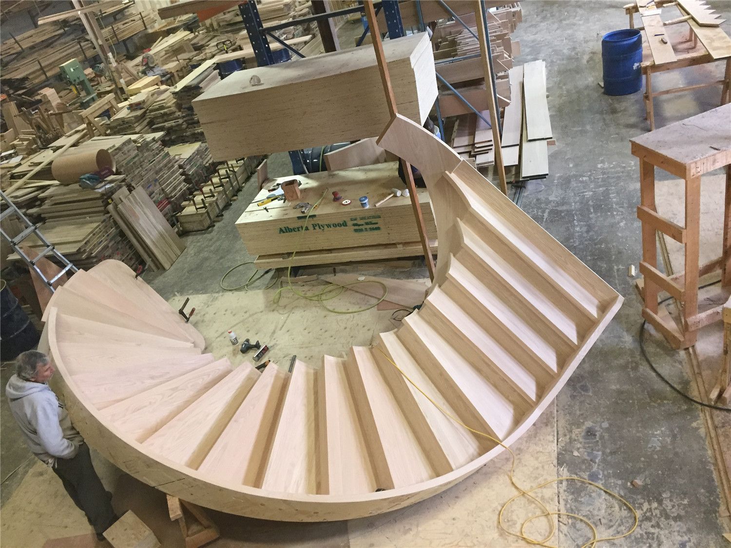 This image shows the fabrication stage of a custom curved hardwood staircase prepared for a Toronto stair renovation project. The precisely shaped stair structure demonstrates advanced woodworking techniques used to create smooth curves and evenly spaced treads. Each step is carefully measured and installed to ensure structural strength, safety, and visual harmony. As a trusted Toronto Renovation Company, Reno Compass Inc. delivers high-quality custom staircase solutions, combining skilled craftsmanship with durable materials for residential projects across Toronto and the Greater Toronto Area.