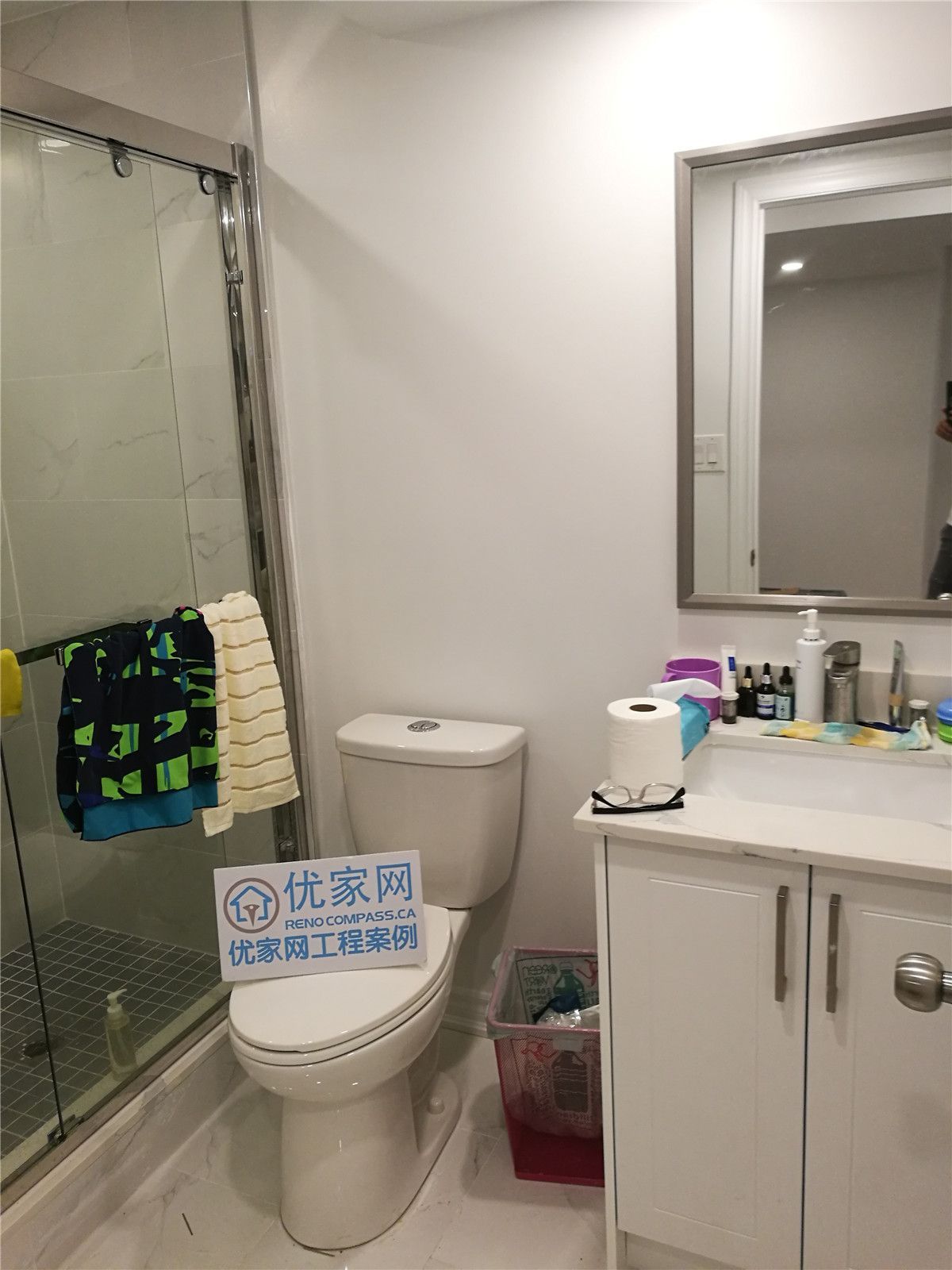 Basement bathroom renovation in Richmond Hill featuring a glass-enclosed shower, modern vanity with quartz countertop, updated toilet, and clean neutral finishes. This bathroom renovation was completed by a professional Toronto renovation company, enhancing functionality, durability, and everyday comfort.