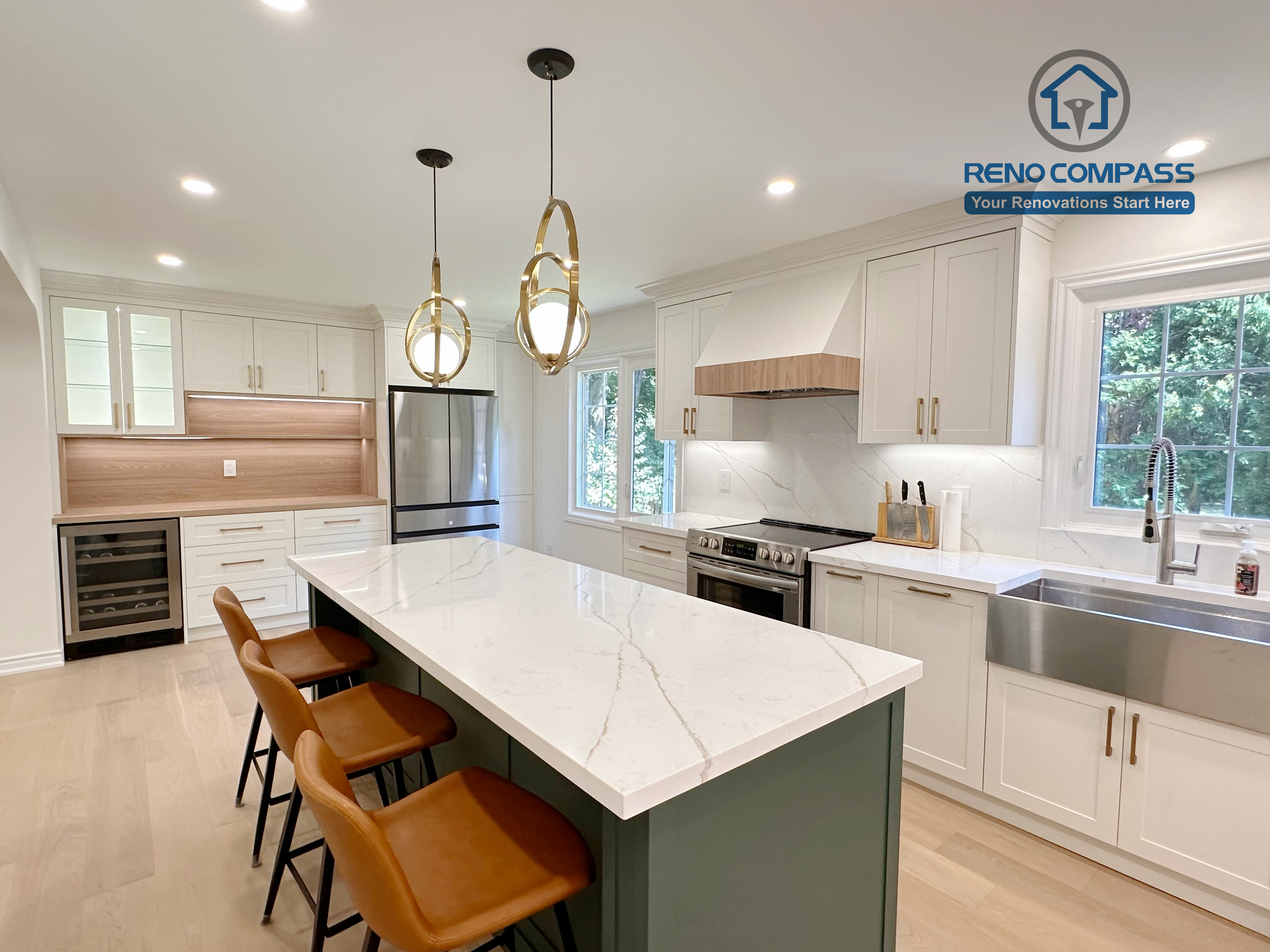 This Markham kitchen renovation highlights a spacious central island with seating, paired with a well-organized cooking area featuring quartz countertops, custom cabinetry, and stainless steel appliances. Pendant lighting and recessed ceiling lights provide balanced illumination, while wide-plank hardwood flooring enhances continuity throughout the space. Completed by a professional Toronto renovation company, Reno Compass Inc., the kitchen is designed for efficiency, comfort, and everyday use.