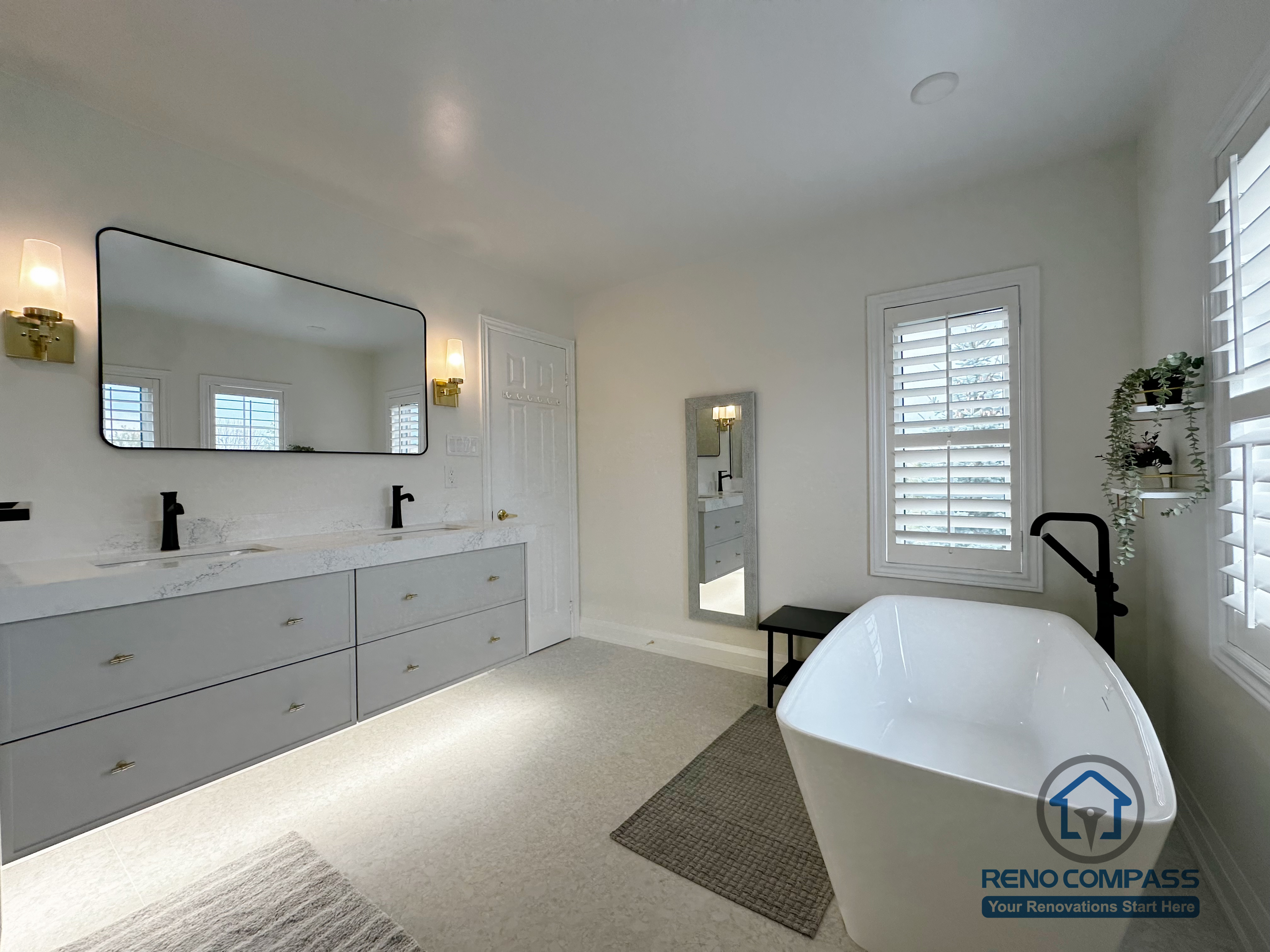 This Markham bathroom renovation features a wide double vanity with quartz countertops, soft integrated lighting, and classic wall sconces. A freestanding bathtub placed near natural light creates a calm, balanced atmosphere, while the overall layout prioritizes comfort, clarity, and everyday usability.