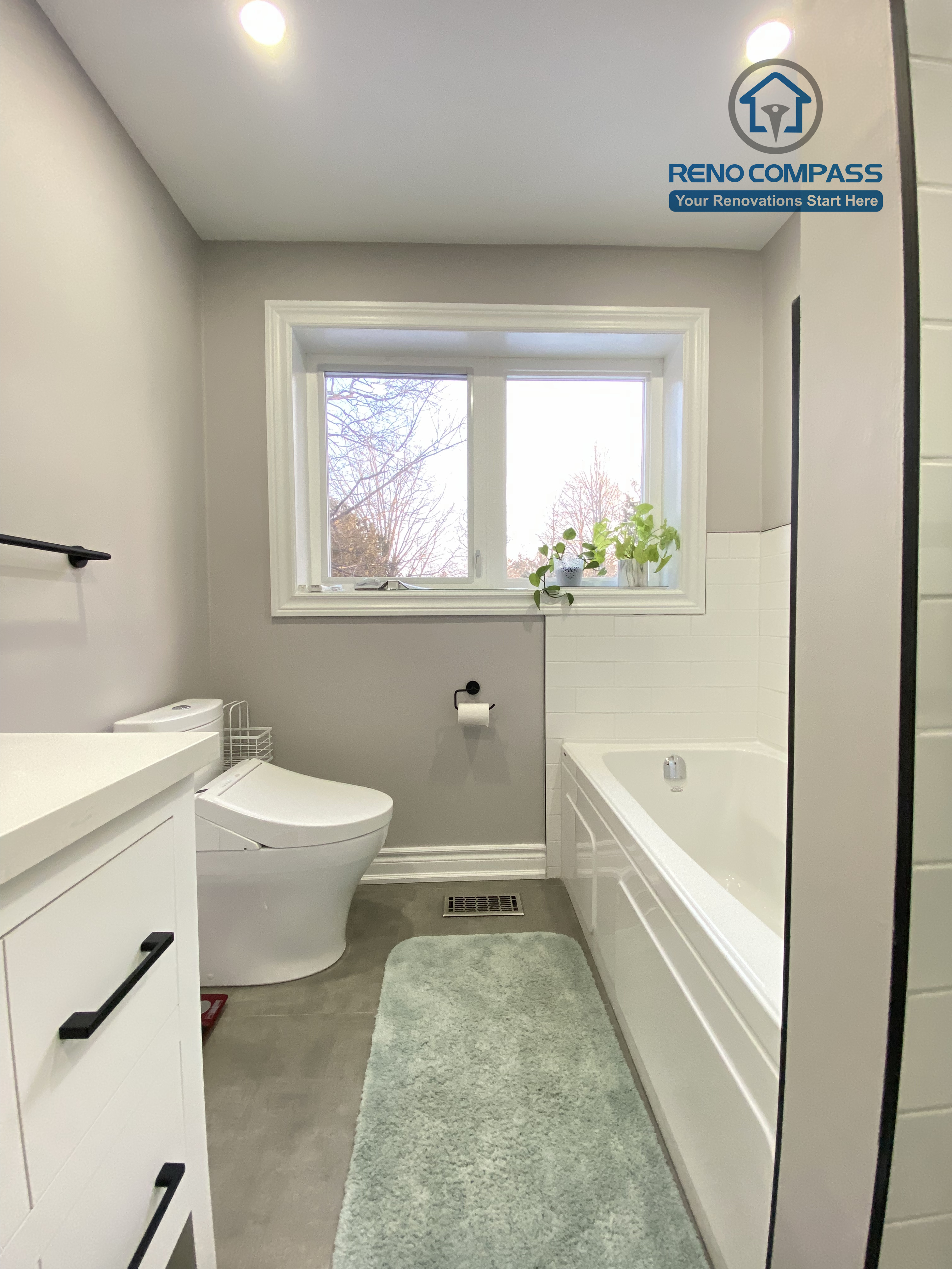 This North York bathroom renovation features a modern white vanity with a quartz countertop, matte black hardware, and a clean, functional layout. The neutral wall color, large-format floor tiles, and integrated lighting create a bright and timeless bathroom design, completed by a Toronto renovation company focused on quality craftsmanship and everyday usability.