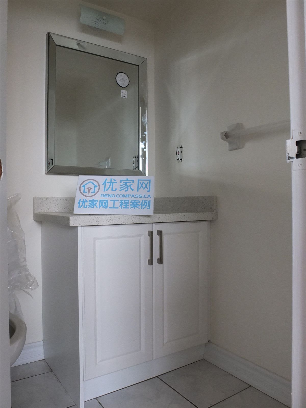 A modern bathroom vanity installation as part of a condo interior renovation in Scarborough. The space features a clean white cabinet, durable countertop, and a simple wall-mounted mirror, creating a bright and functional bathroom layout. This renovation improves storage, usability, and overall aesthetics, completed by a professional Toronto renovation company.
