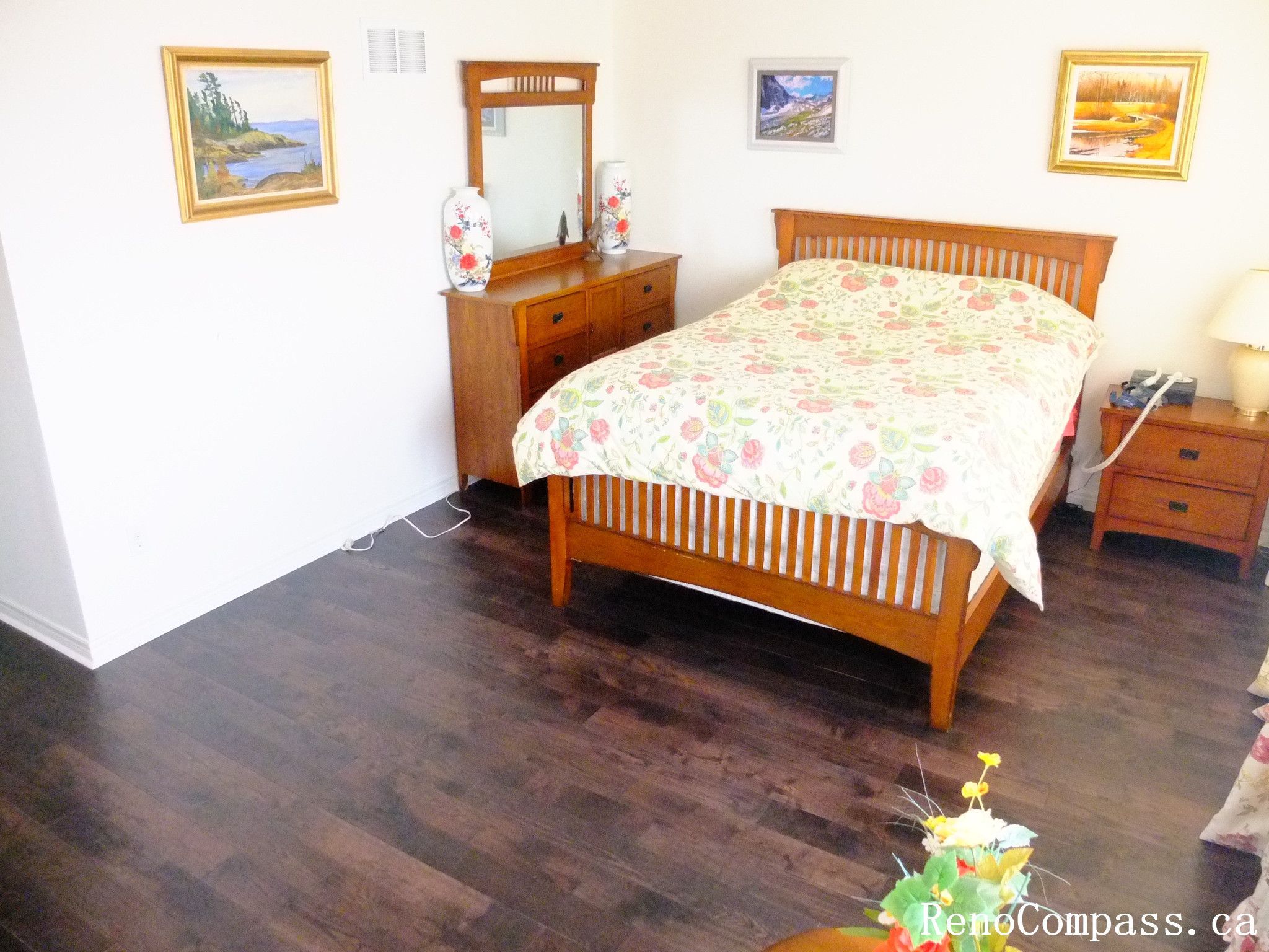 Toronto home hardwood flooring installation featuring deep-toned wood floors throughout the hallway and upper level. This professional flooring renovation enhances brightness, durability, and visual continuity, completed by Reno Compass for a clean and modern interior upgrade.