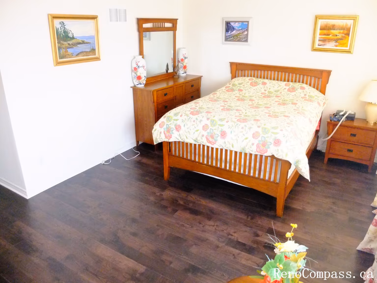 Toronto home hardwood flooring installation featuring deep-toned wood floors throughout the hallway and upper level. This professional flooring renovation enhances brightness, durability, and visual continuity, completed by Reno Compass for a clean and modern interior upgrade.