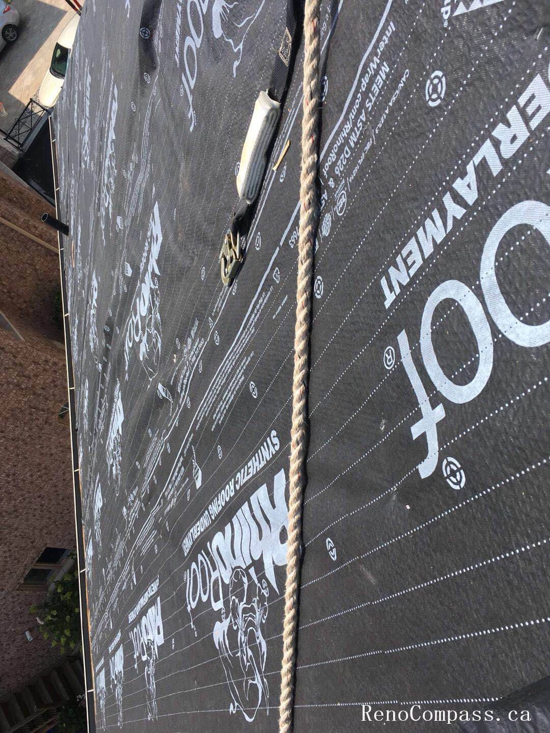 This image captures the mid-stage of a roofing replacement project in Toronto, showing newly installed roof decking and waterproof underlayment preparation. The old roofing materials have been removed to expose the wooden roof structure, allowing the team to reinforce the base and ensure proper alignment before installing new shingles. High-quality waterproof membrane layers are applied to enhance moisture protection and improve long-term durability against Toronto’s harsh weather conditions. This professional roofing replacement process ensures structural integrity, proper insulation support, and a reliable foundation for the final roofing system installation on residential properties.