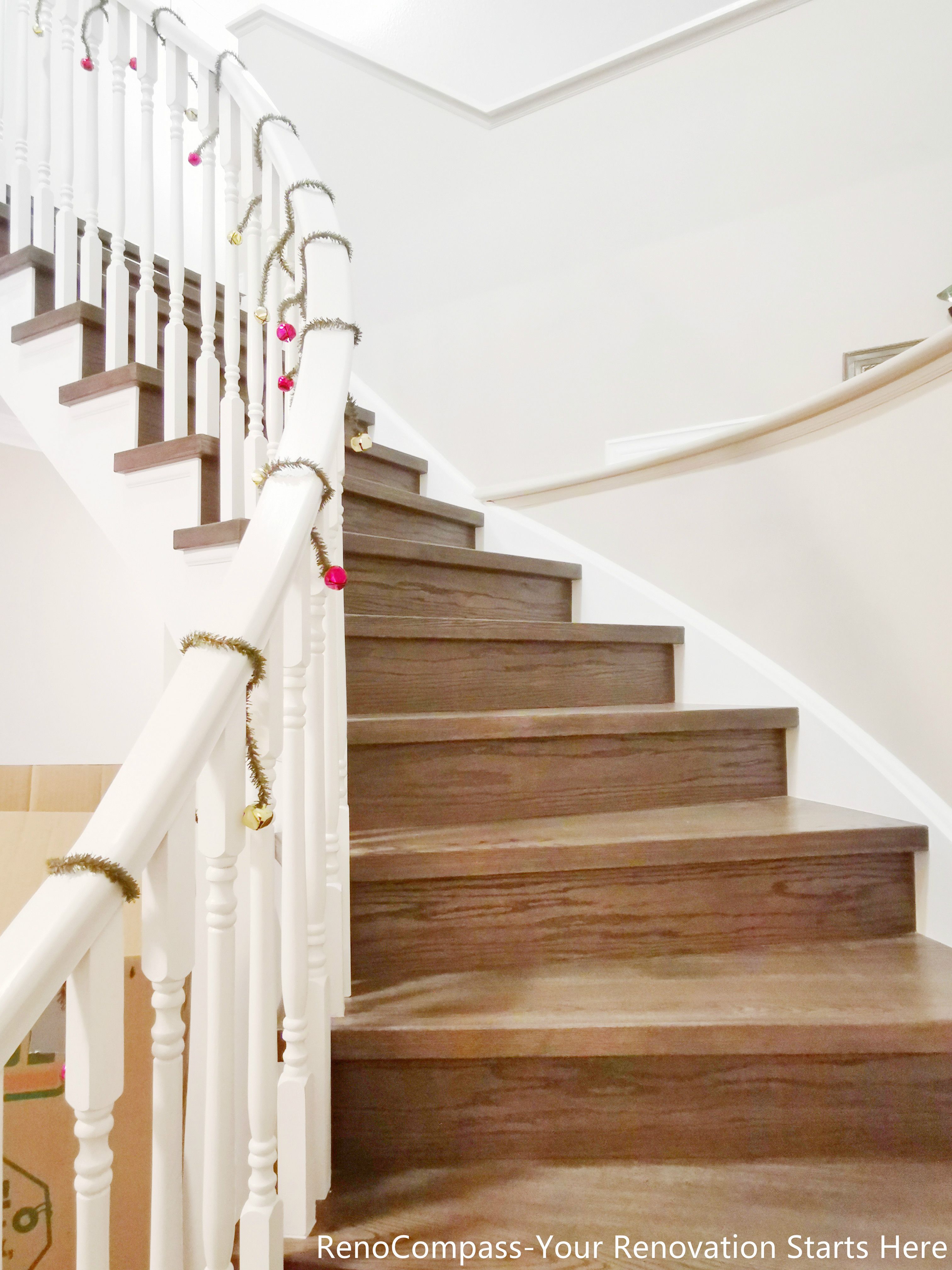 This curved staircase features solid wood treads paired with white balusters and a smooth handrail, creating a clean and timeless transition between floors. The natural wood tone adds warmth, while the curved design enhances flow and visual softness within the Oakville home.