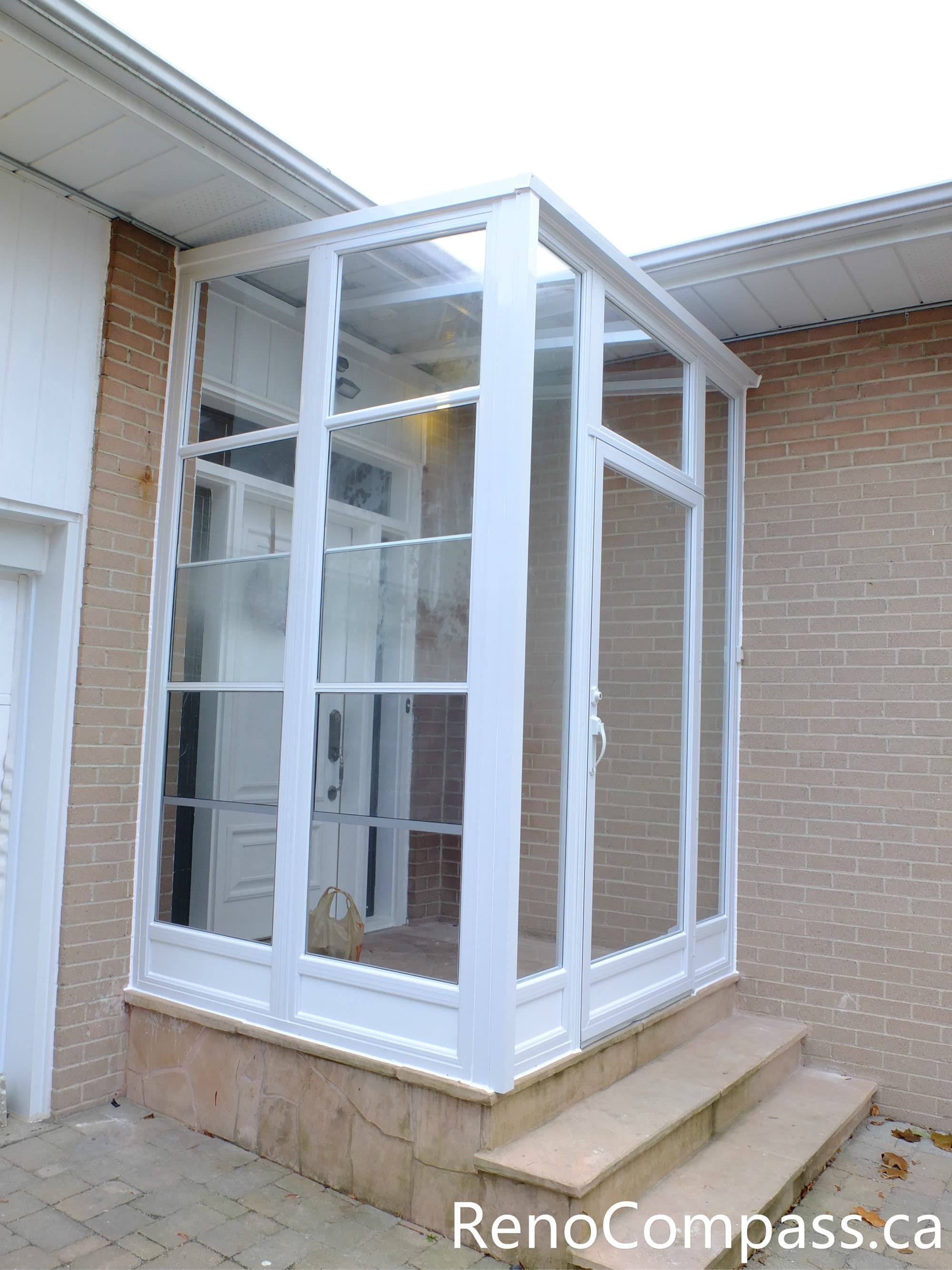 A custom-installed storm door and glass entry enclosure in North York, designed to enhance weather protection, energy efficiency, and curb appeal. This project features a white aluminum frame with full-height glass panels, providing a clean, modern look while allowing natural light to enter the home. Professionally installed to integrate seamlessly with the existing brick exterior, this storm door solution improves insulation and adds a functional transitional space at the front entrance.