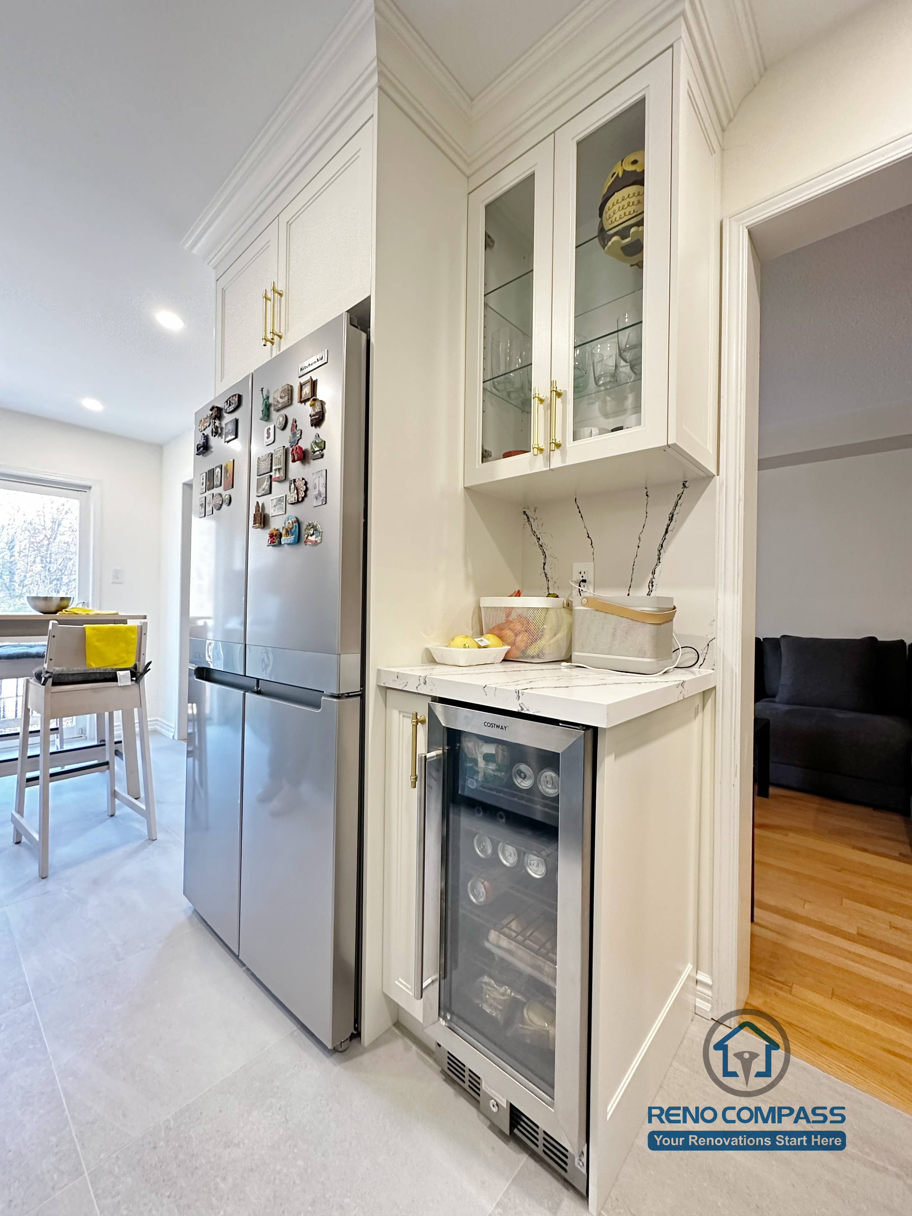This Mississauga kitchen renovation highlights a custom built-in storage area with integrated appliances, glass-front cabinetry, and quartz countertops. The design maximizes corner space, improves organization, and adds functional storage while maintaining a clean and cohesive kitchen layout.