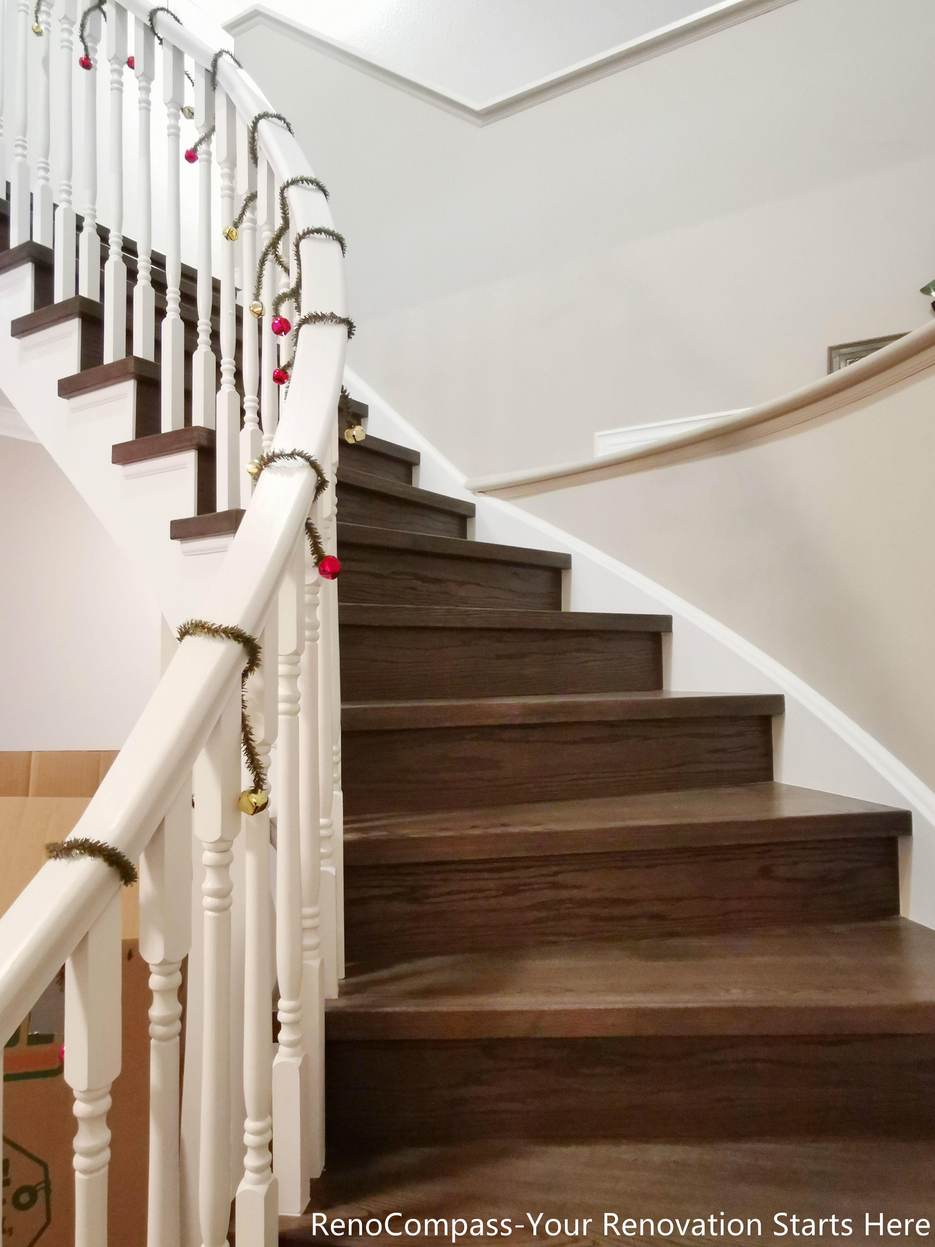 This curved staircase features warm wood treads paired with classic white balusters, creating a clean and timeless transition between levels. The gentle curve softens the vertical circulation, while the contrast between natural wood and crisp white railings adds visual balance and architectural elegance. Designed to blend seamlessly into the overall interior renovation, this staircase enhances both functionality and flow within the Oakville home.