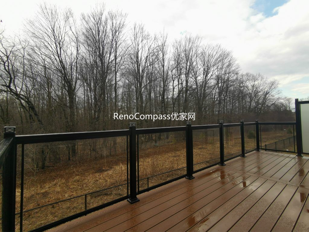 Professional deck construction project in Aurora featuring durable composite wood decking, modern black aluminum and glass railings, and a spacious outdoor layout. Designed for long-term durability and low maintenance, this backyard deck enhances outdoor comfort, safety, and property value.