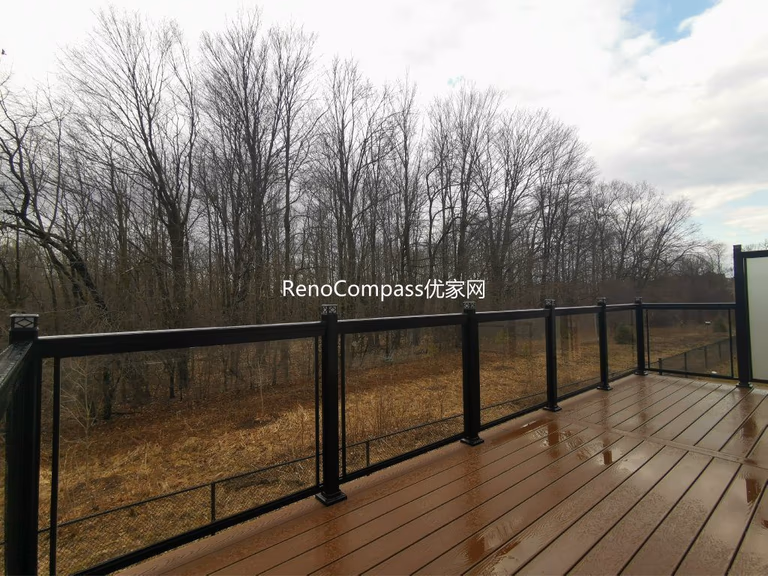 Professional deck construction project in Aurora featuring durable composite wood decking, modern black aluminum and glass railings, and a spacious outdoor layout. Designed for long-term durability and low maintenance, this backyard deck enhances outdoor comfort, safety, and property value.