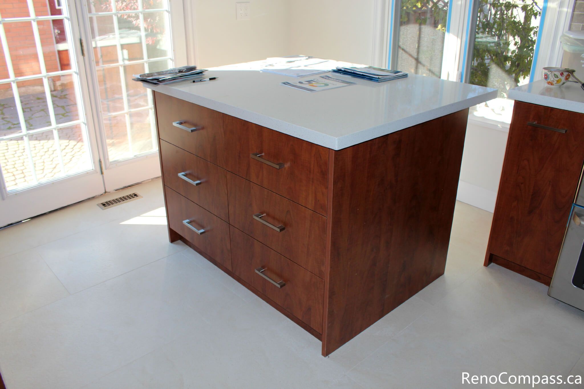 This custom kitchen island is part of a full house renovation project in Mississauga completed by a professional Toronto renovation company. Featuring a spacious quartz countertop, rich wood cabinetry, and built-in storage drawers, the island enhances both functionality and visual appeal. Designed to improve workflow, storage capacity, and natural light flow, this modern kitchen upgrade creates a practical and welcoming centerpiece for everyday cooking and family gatherings.