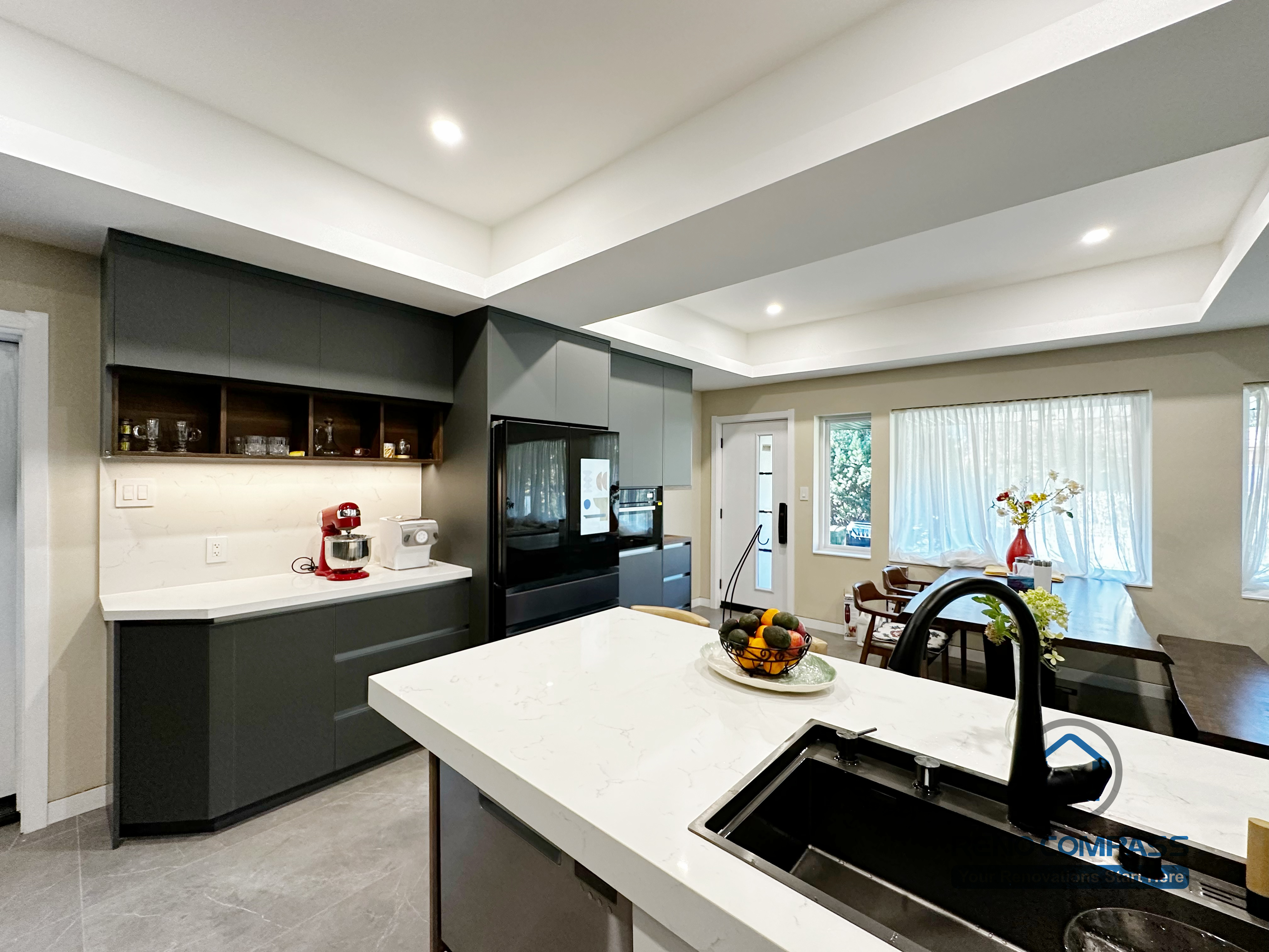 Modern kitchen completed as part of a North York interior renovation. This space features a large central island with integrated sink, custom cabinetry, built-in appliances, and clean-lined finishes. The open layout connects seamlessly with the dining area, enhancing functionality and everyday flow. Designed and built by a professional Toronto renovation company.