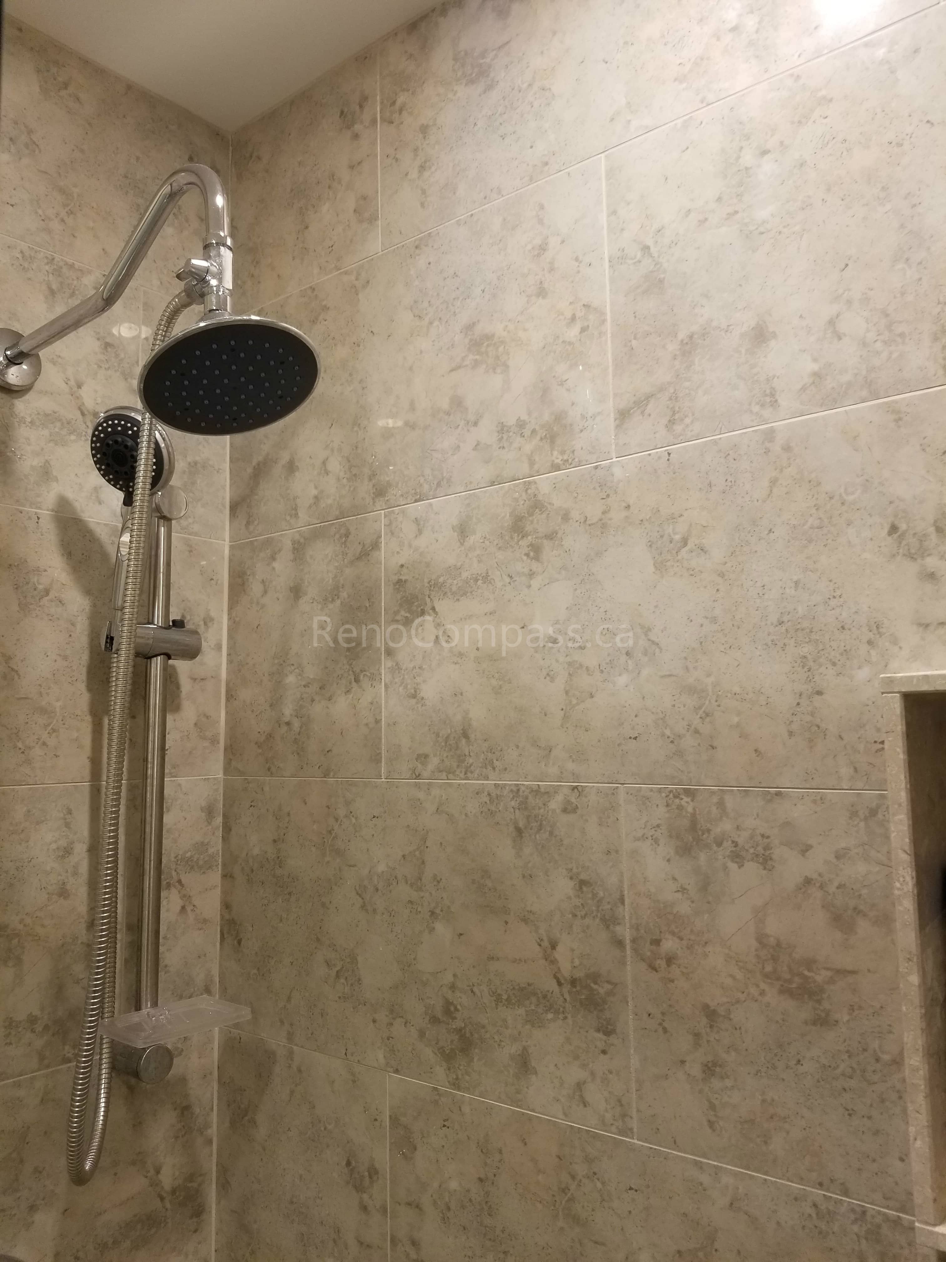 This Markham bathroom renovation features a newly installed rain shower system with handheld shower attachment, paired with modern wall tile installation for a clean and elegant finish. The upgraded shower area offers improved functionality, better water flow control, and a spa-like experience. As part of a full bathroom remodel including new flooring and vanity, the refreshed shower enhances comfort, durability, and overall modern design.